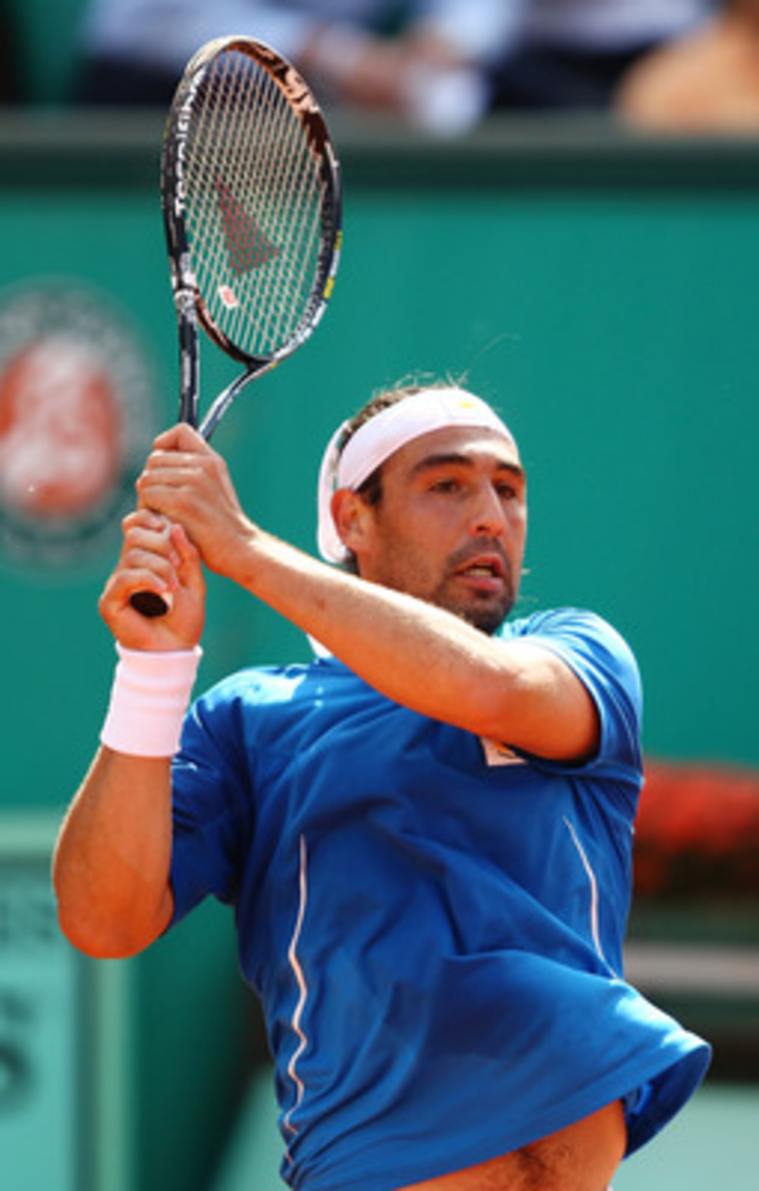 PARIS - MAY 28:  Marcos Baghdatis of Cyprus plays a forehand during the men's singles third round match between Andy Murray of Great Britain and Marcos Baghdatis of Cyprus at the French Open on day six of the French Open at Roland Garros on May 28, 2010 i