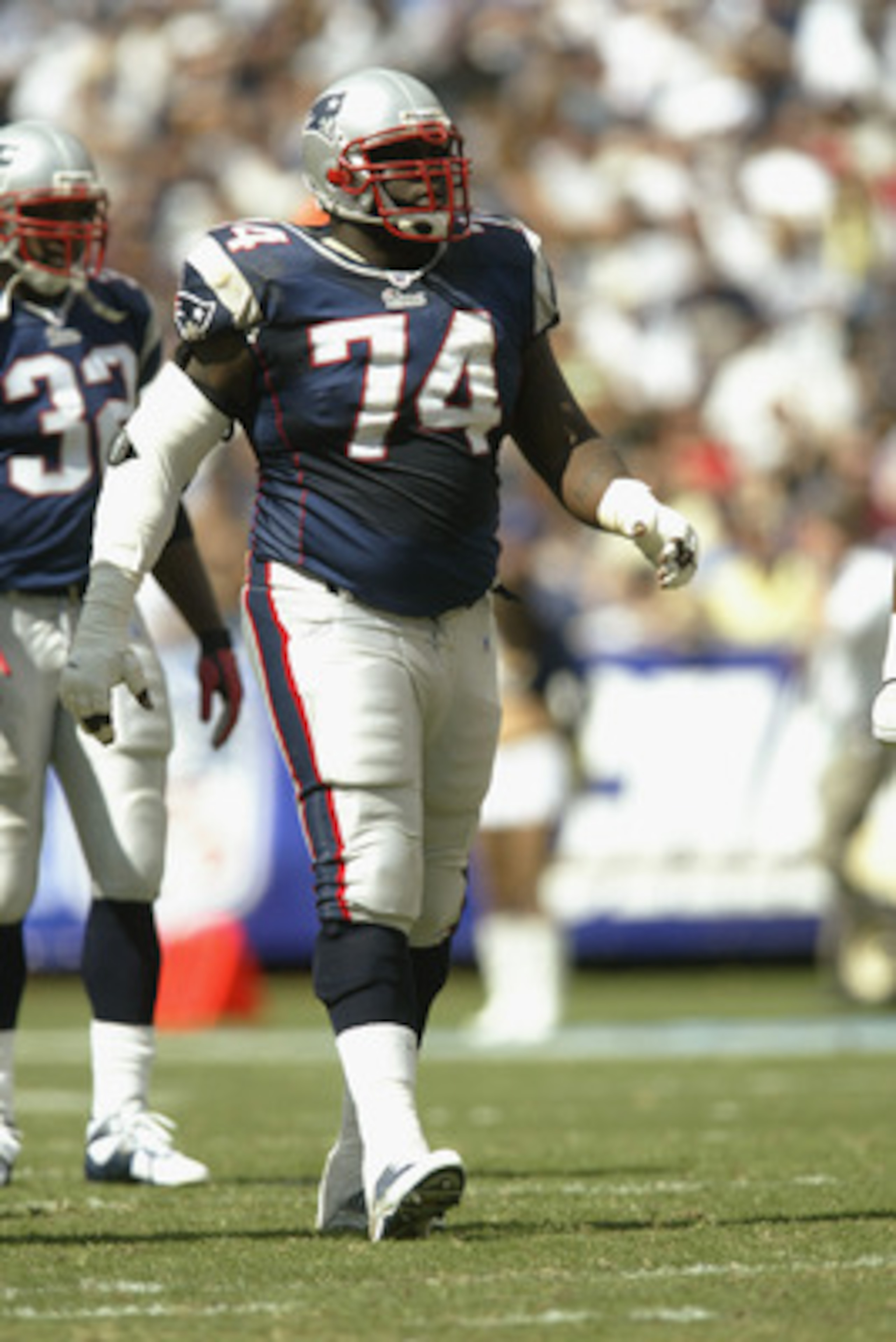 SAN DIEGO - SEPTEMBER 29:  Tackle Kenyatta Jones #74 of the New England Patriots walks on the field during the NFL game against the San Diego Chargers on September 29, 2002 at Qualcomm Stadium in San Diego, California.  The Chargers won 21-14. (Photo by S