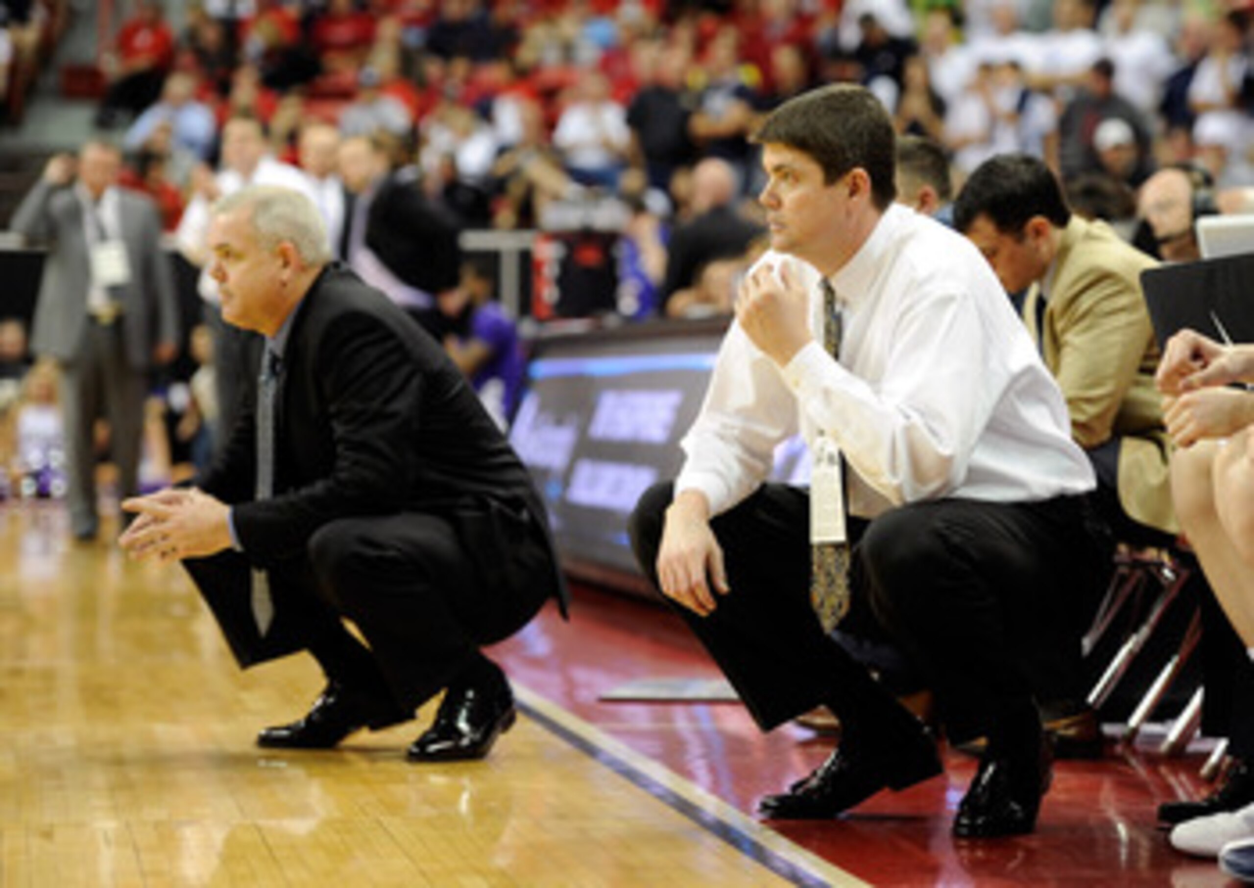 LAS VEGAS, NV - MARCH 10:  Head coach Dave Rose (L) and associate head coach Dave Rice of the Brigham Young University Cougars look on during the team's 64-58 victory over the Texas Christian University Horned Frogs in a quarterfinal game of the Conoco Mo