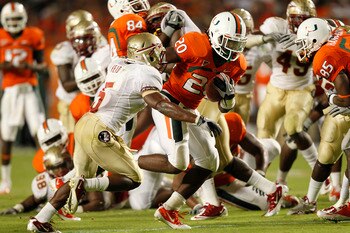 MIAMI, FL - OCTOBER 9: Damien Berry #20 of the Miami Hurricanes breaks the tackle of Greg Reid #5 of the Florida State Seminoles to score a touchdown in the third quarter on October 9, 2010 at Sun Life Stadium in Miami, Florida. The Seminoles defeated the