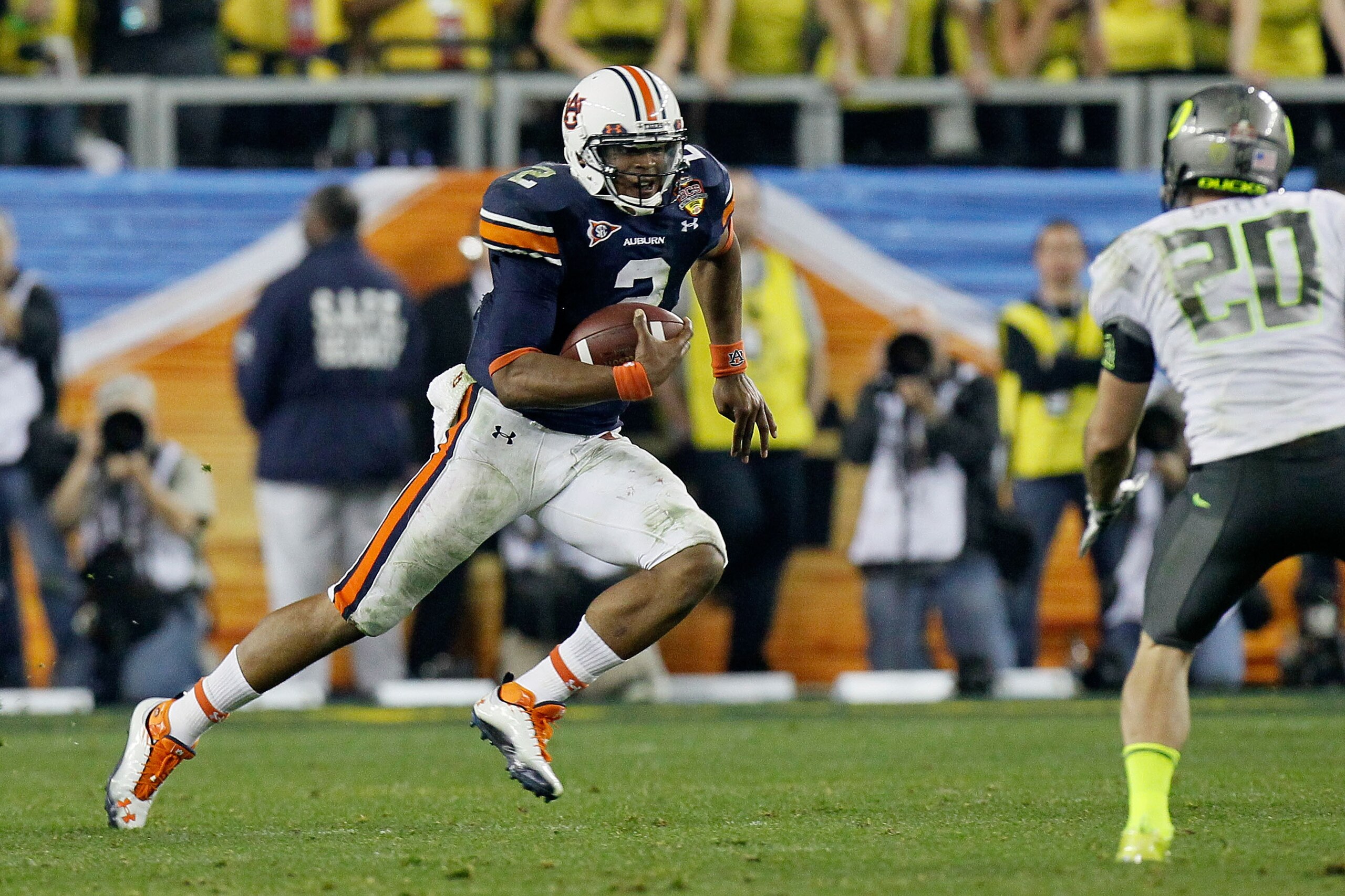 GLENDALE, AZ - JANUARY 10:  Cameron Newton #2 of the Auburn Tigers runs down field against John Boyett #20 of the Oregon Ducks during the Tostitos BCS National Championship Game at University of Phoenix Stadium on January 10, 2011 in Glendale, Arizona.  (