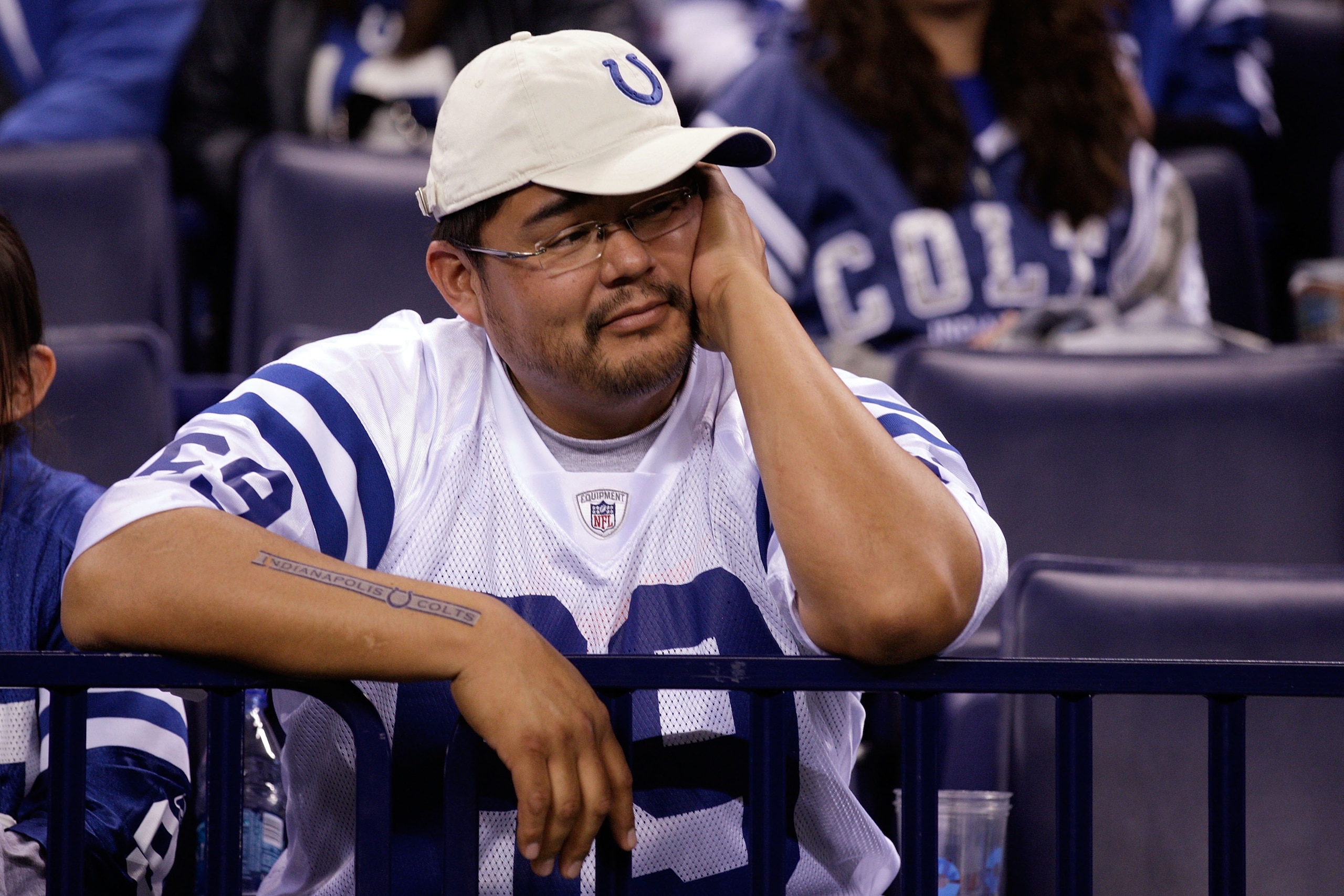 INDIANAPOLIS, IN - JANUARY 08:  A fan of the Indianapolis Colts looks on dejected after the COlts lost 17-16 against the New York Jets during their 2011 AFC wild card playoff game at Lucas Oil Stadium on January 8, 2011 in Indianapolis, Indiana.  (Photo b