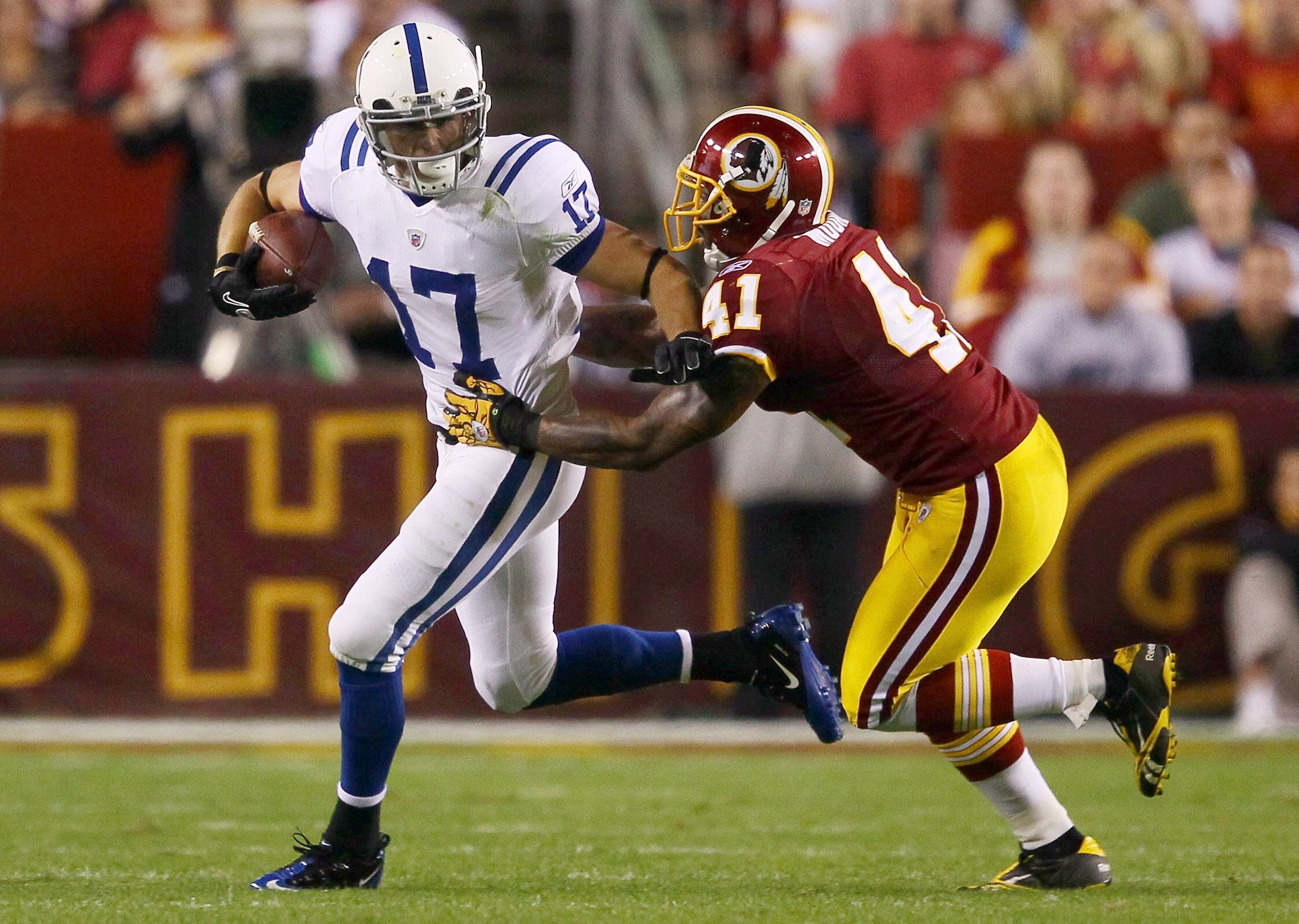 LANDOVER, MD - OCTOBER 17: Austin Collie #17 of the Indianapolis Colts moves the ball upfield after making a reception against Kareem Moore #41 of the Washington Redskins at FedExField on October 17, 2010 in Landover, Maryland. (Photo by Win McNamee/Gett LANDOVER, MD - OCTOBER 17: Austin Collie #17 of the Indianapolis Colts moves the ball upfield after making a reception against Kareem Moore #41 of the Washington Redskins at FedExField on October 17, 2010 in Landover, Maryland. (Photo by Win McNamee/Gett
