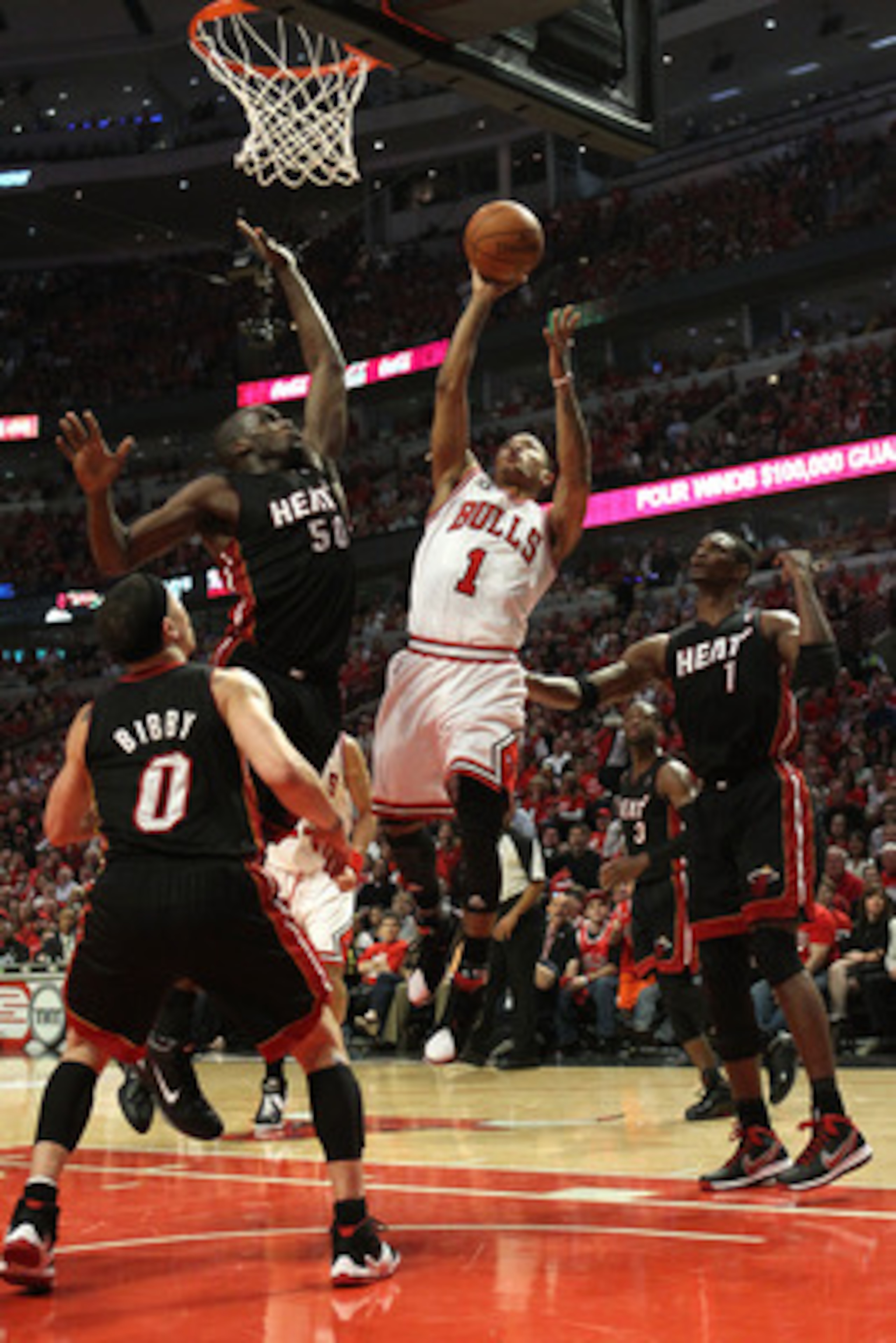 CHICAGO, IL - MAY 15: Derrick Rose #1 of the Chicago Bulls attempts a shot against Mike Bibby #0, Joel Anthony #50 and Chris Bosh #1 of the Miami Heat in Game One of the Eastern Conference Finals during the 2011 NBA Playoffs on May 15, 2011 at the United CHICAGO, IL - MAY 15: Derrick Rose #1 of the Chicago Bulls attempts a shot against Mike Bibby #0, Joel Anthony #50 and Chris Bosh #1 of the Miami Heat in Game One of the Eastern Conference Finals during the 2011 NBA Playoffs on May 15, 2011 at the United