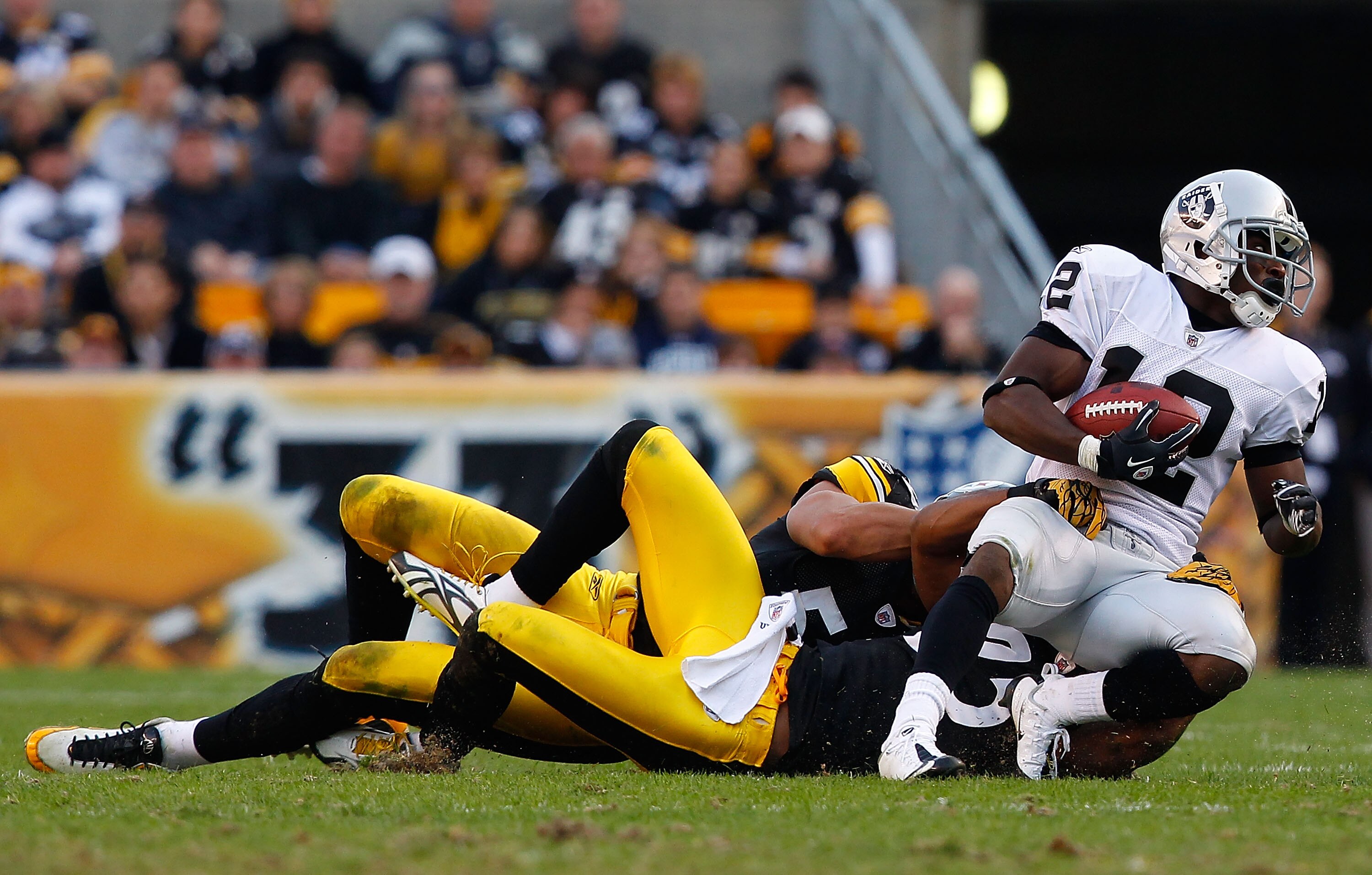 PITTSBURGH, PA - NOVEMBER 21: Ryan Clark #25 and James Farrior #51 of the Pittsburgh Steelers tackle Jacoby Ford #12 of the Oakland Raiders during the game on November 21, 2010 at Heinz Field in Pittsburgh, Pennsylvania. (Photo by Jared Wickerham/Getty PITTSBURGH, PA - NOVEMBER 21: Ryan Clark #25 and James Farrior #51 of the Pittsburgh Steelers tackle Jacoby Ford #12 of the Oakland Raiders during the game on November 21, 2010 at Heinz Field in Pittsburgh, Pennsylvania. (Photo by Jared Wickerham/Getty