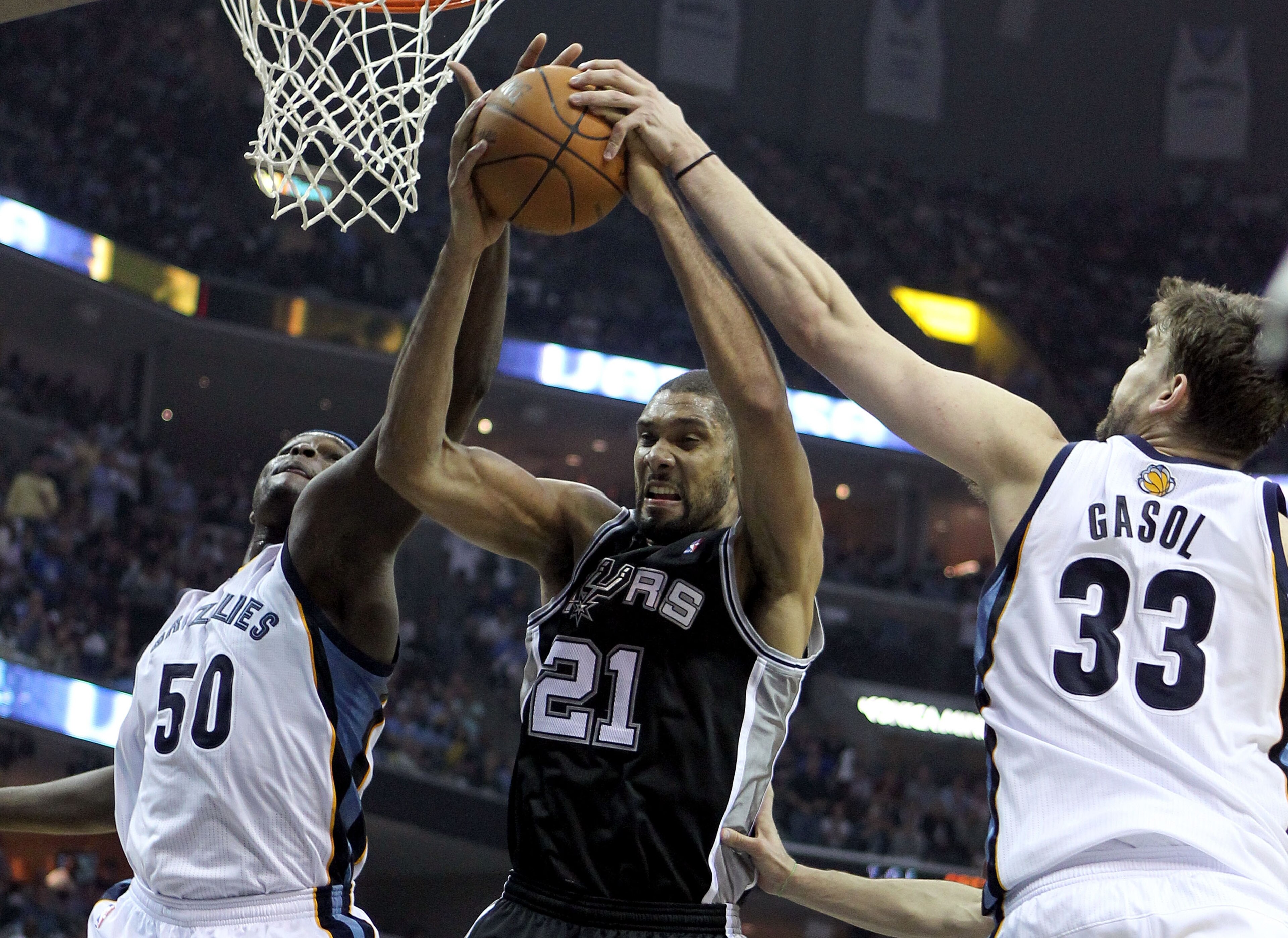 MEMPHIS, TN - APRIL 29:  Zach Randolph #50 and Marc Gasol #33 of the Memphis Grizzlies and Tim Duncan #21 of the San Antonio Spurs reach for a rebound in Game Six of the Western Conference Quarterfinals in the 2011 NBA Playoffs at FedExForum on April 29,