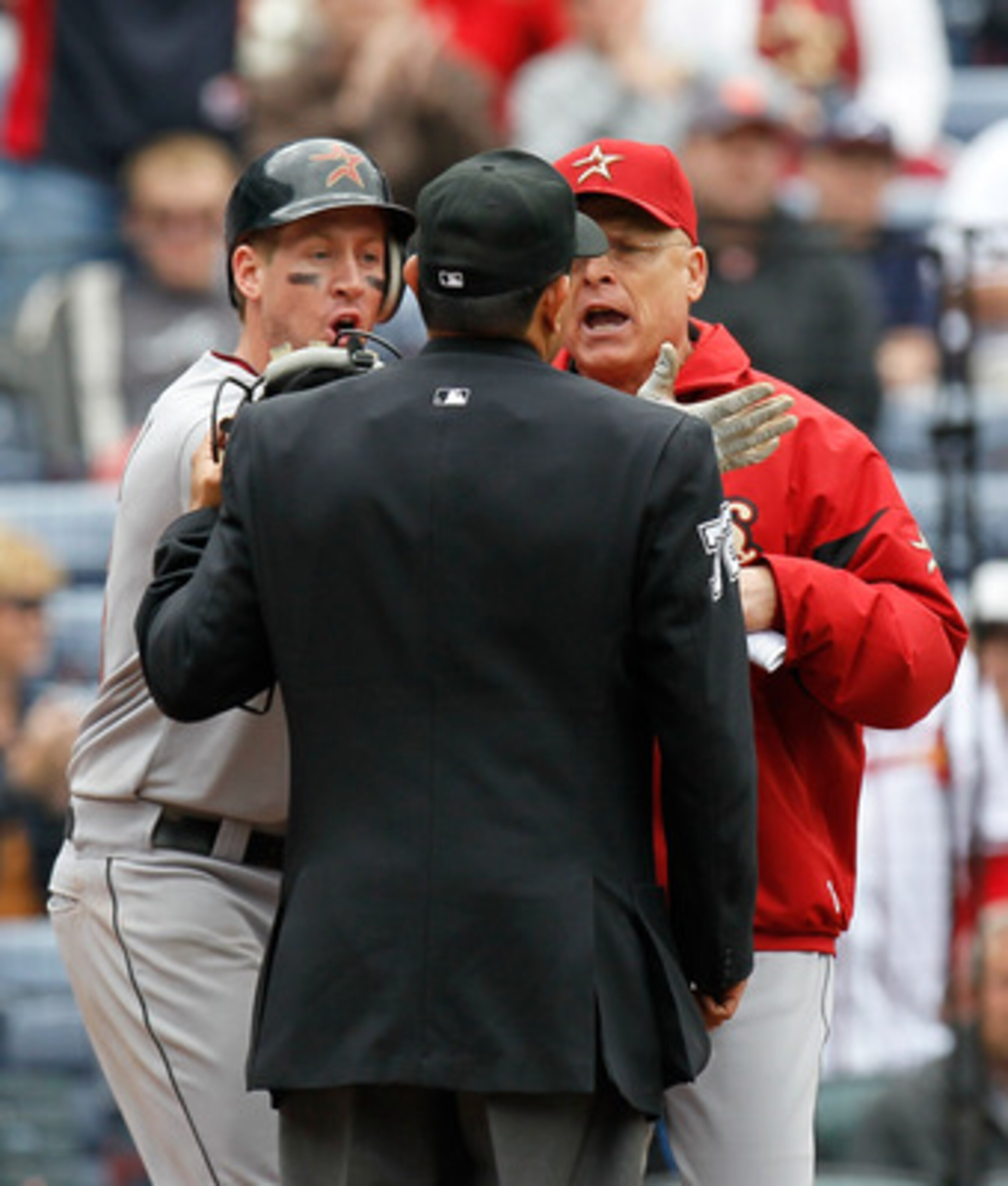 ATLANTA, GA - MAY 17:  Matt Downs #16 and manager Brad Mills of the Houston Astros argue with homeplate umpire Alfonso Marquez #72 after Downs appeared to be hit by a pitch but it was ruled a foul ball in the 11th inning against the Atlanta Braves at Turn