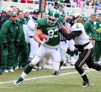 EAST LANSING, MI - NOVEMBER 08:  Charlie Gantt #83 of the Michigan State Spartans runs the ball against Torri Williams #2 of the Purdue Boilermakers at Spartan Stadium on November 8, 2008 in East Lansing, Michigan.  (Photo by Jim McIsaac/Getty Images)