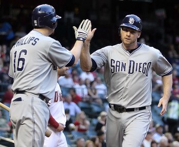 PHOENIX, AZ - MAY 16:  Chase Headley #7 of the San Diego Padres high fives teammate Kyle Phillips #16 after scoring a first inning run against the Arizona Diamondbacks during the Major League Baseball game at Chase Field on May 16, 2011 in Phoenix, Arizon