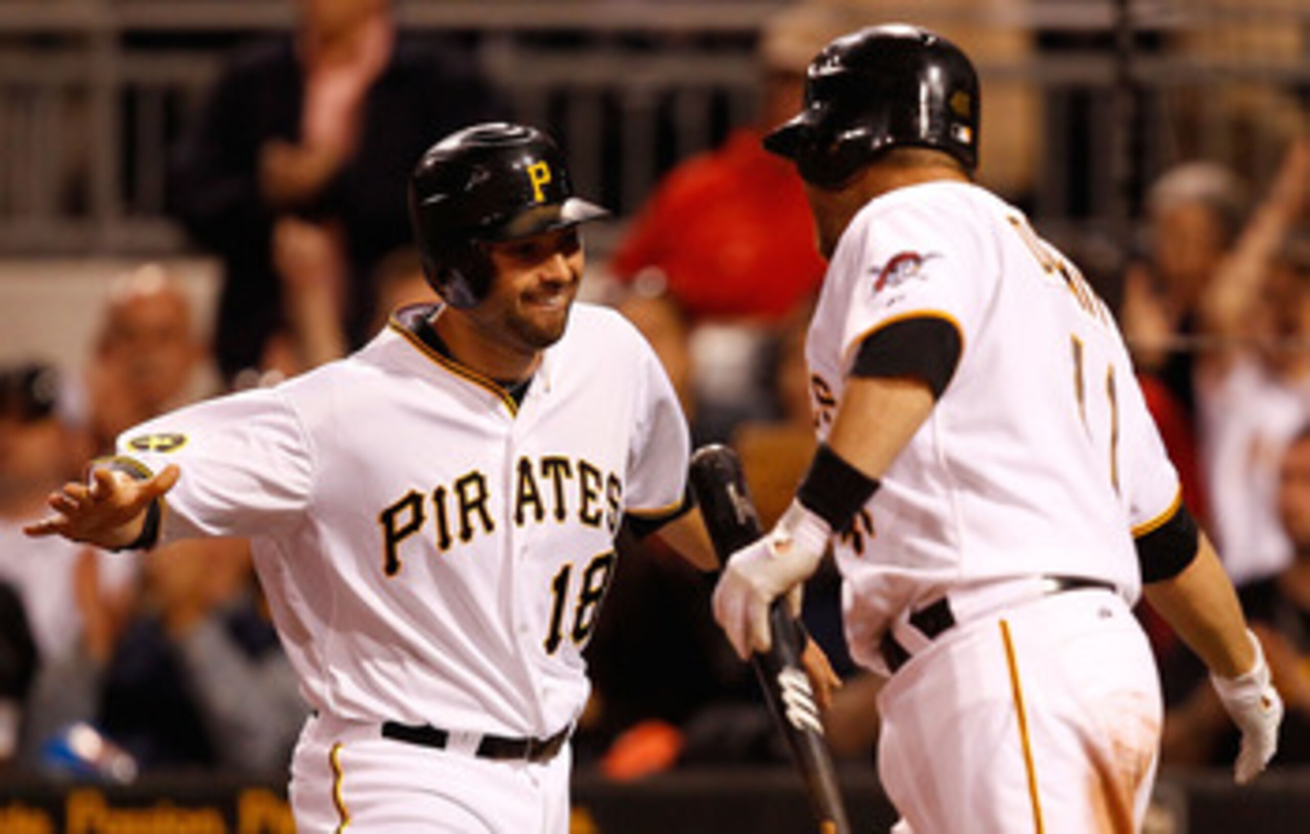 PITTSBURGH - MAY 09:  Neil Walker #18 of the Pittsburgh Pirates celebrates with teammate Ryan Doumit #41 after scoring in the 8th inning against the Los Angeles Dodgers during the game on May 9, 2011 at PNC Park in Pittsburgh, Pennsylvania.  (Photo by Jar