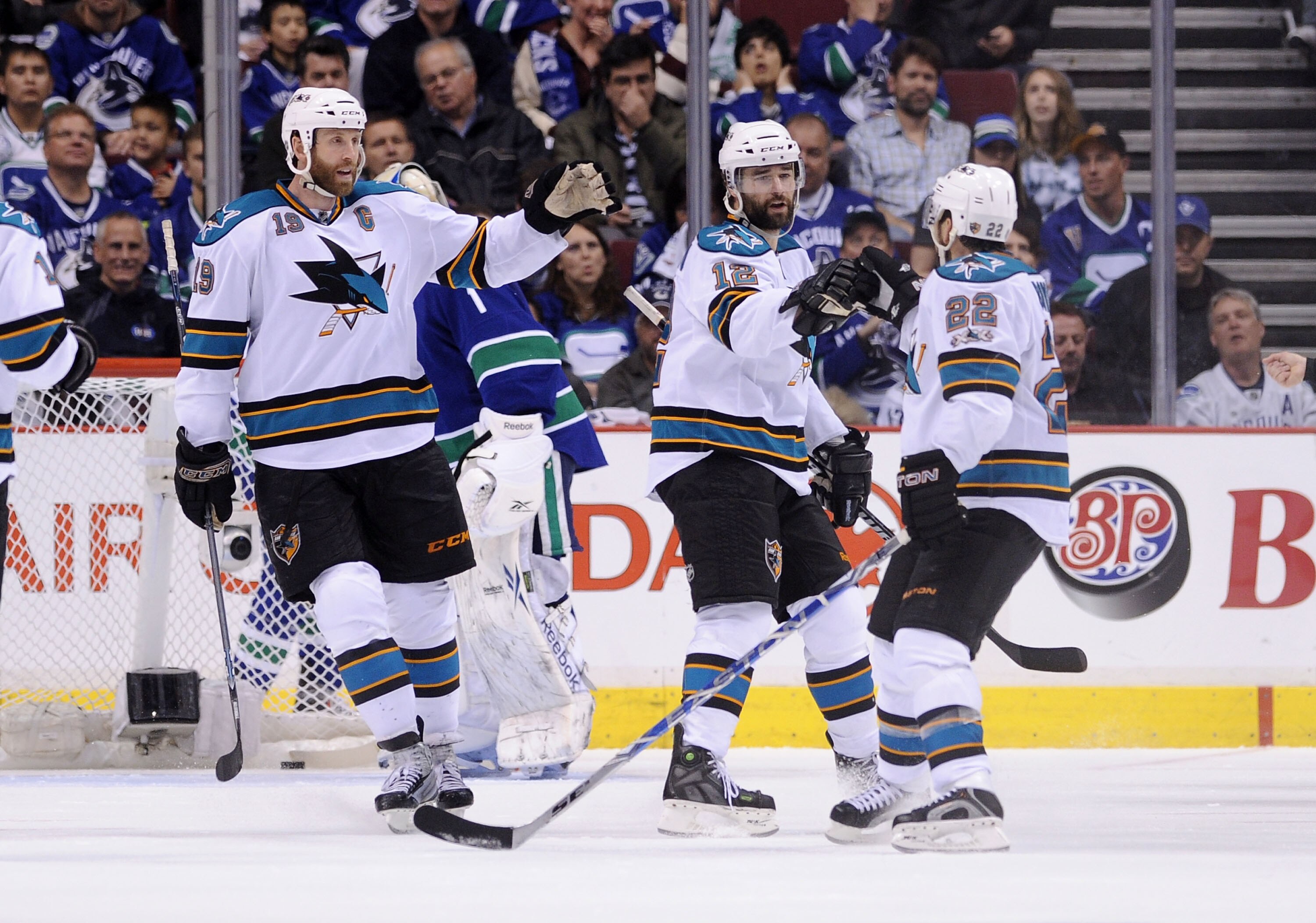 VANCOUVER, CANADA - MAY 15: Joe Thornton #19 and Dan Boyle #22 of the San Jose Sharks congratulate teammate Patrick Marleau #12 after Marleau's goal against the Vancouver Canucks in the second period in Game One of the Western Conference Finals during the