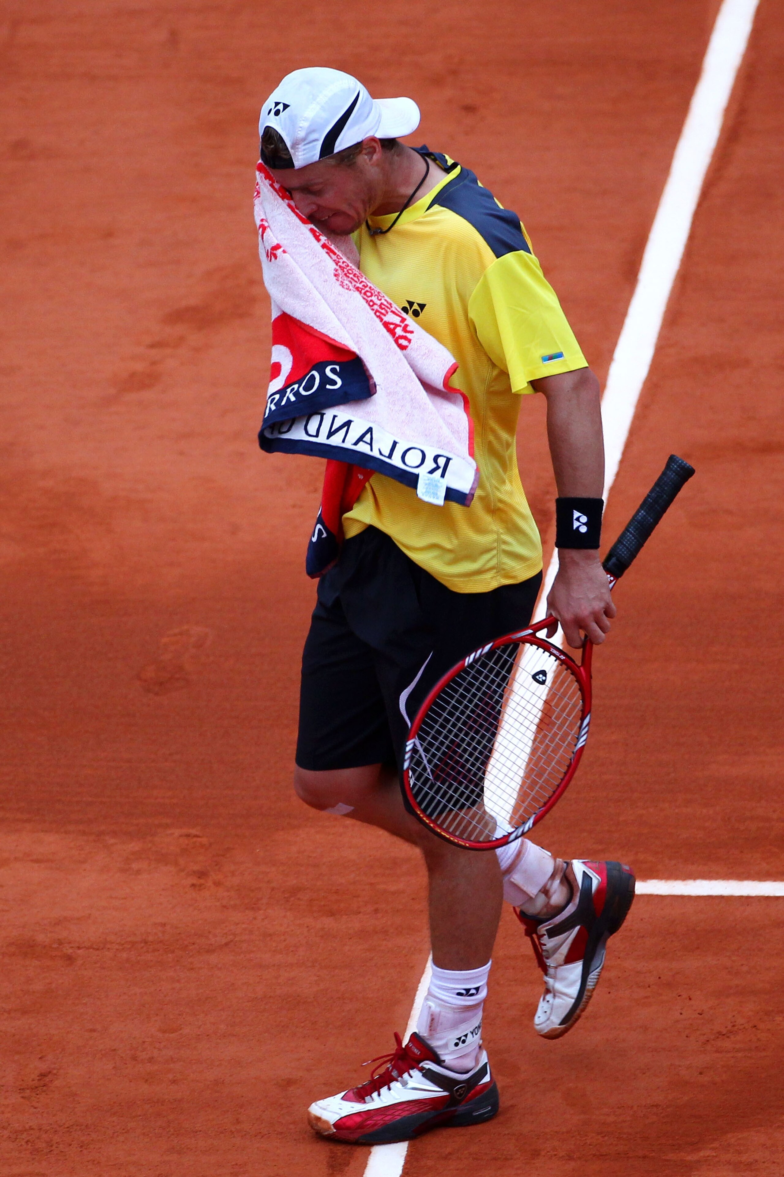 PARIS - MAY 29:  Lleyton Hewitt of Australia shows his dejection as he wipes his face with a towel during the men's singles third round match between Rafael Nadal of Spain and Lleyton Hewitt of Australia on day seven of the French Open at Roland Garros on