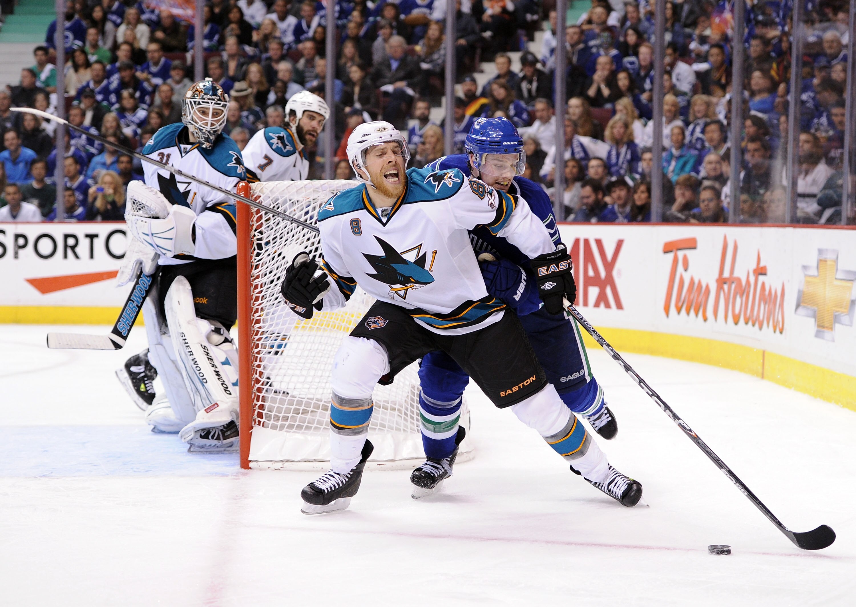 VANCOUVER, CANADA - MAY 15:  Mason Raymond #21 of the Vancouver Canucks skates after the puck on the forecheck against Joe Pavelski #8 of the San Jose Sharks in Game One of the Western Conference Finals during the 2011 Stanley Cup Playoffs at Rogers Arena