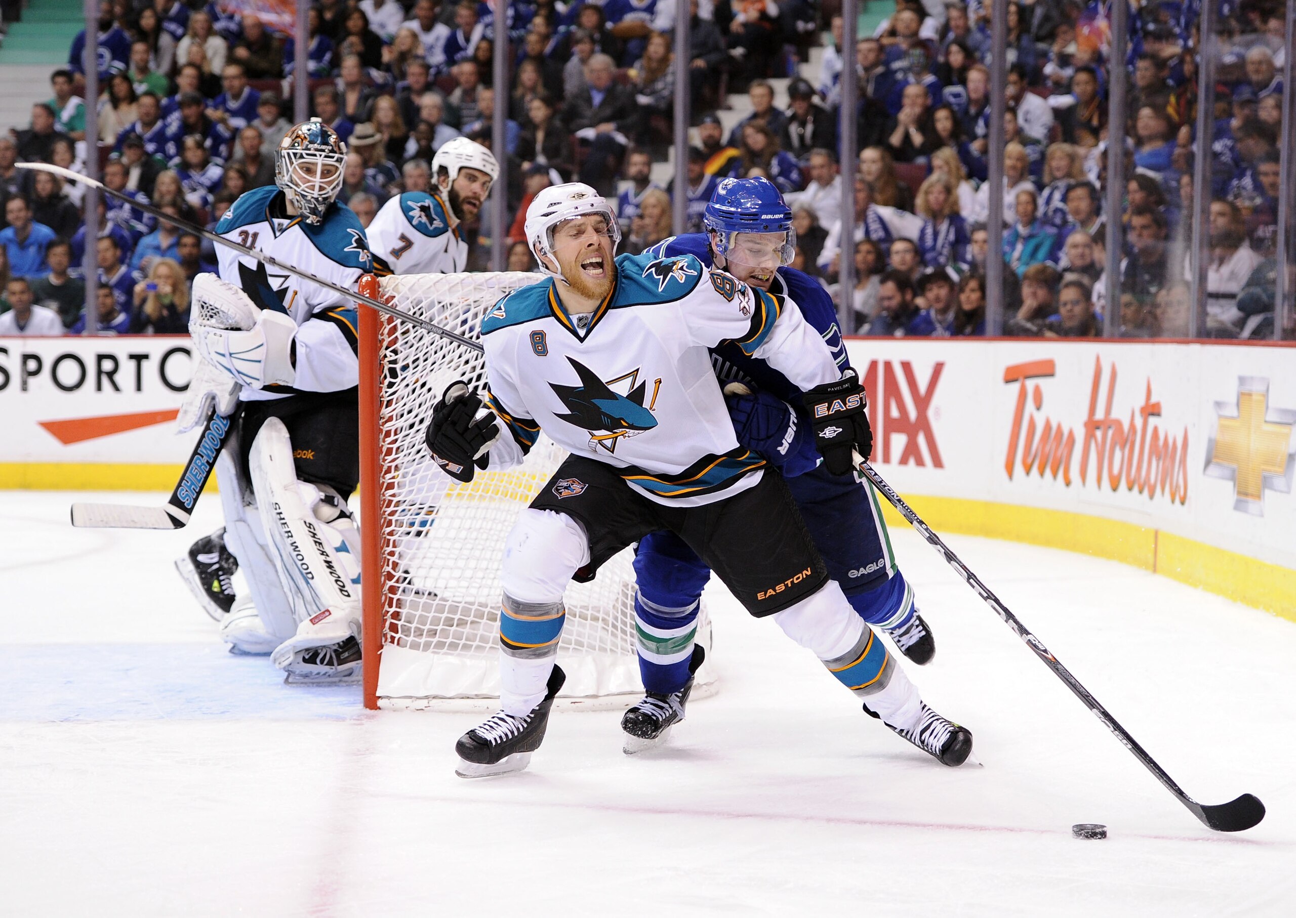 VANCOUVER, CANADA - MAY 15:  Mason Raymond #21 of the Vancouver Canucks skates after the puck on the forecheck against Joe Pavelski #8 of the San Jose Sharks in Game One of the Western Conference Finals during the 2011 Stanley Cup Playoffs at Rogers Arena