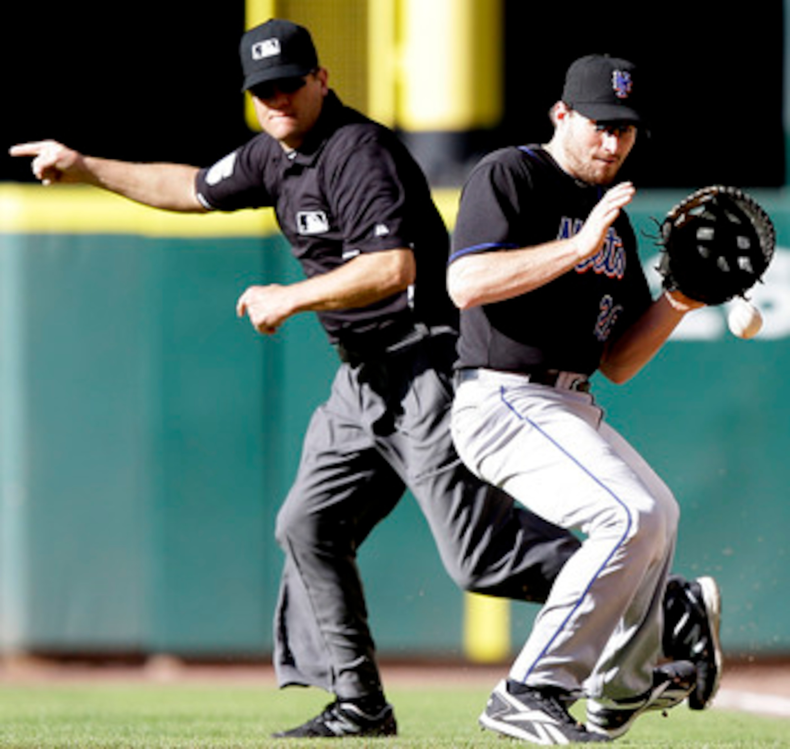 HOUSTON - MAY 14:  First baseman Daniel Murphy #28 of the New York Mets fields a ball as first base umpire Chad Fairchild signals fair at Minute Maid Park on May 14, 2011 in Houston, Texas.  (Photo by Bob Levey/Getty Images)