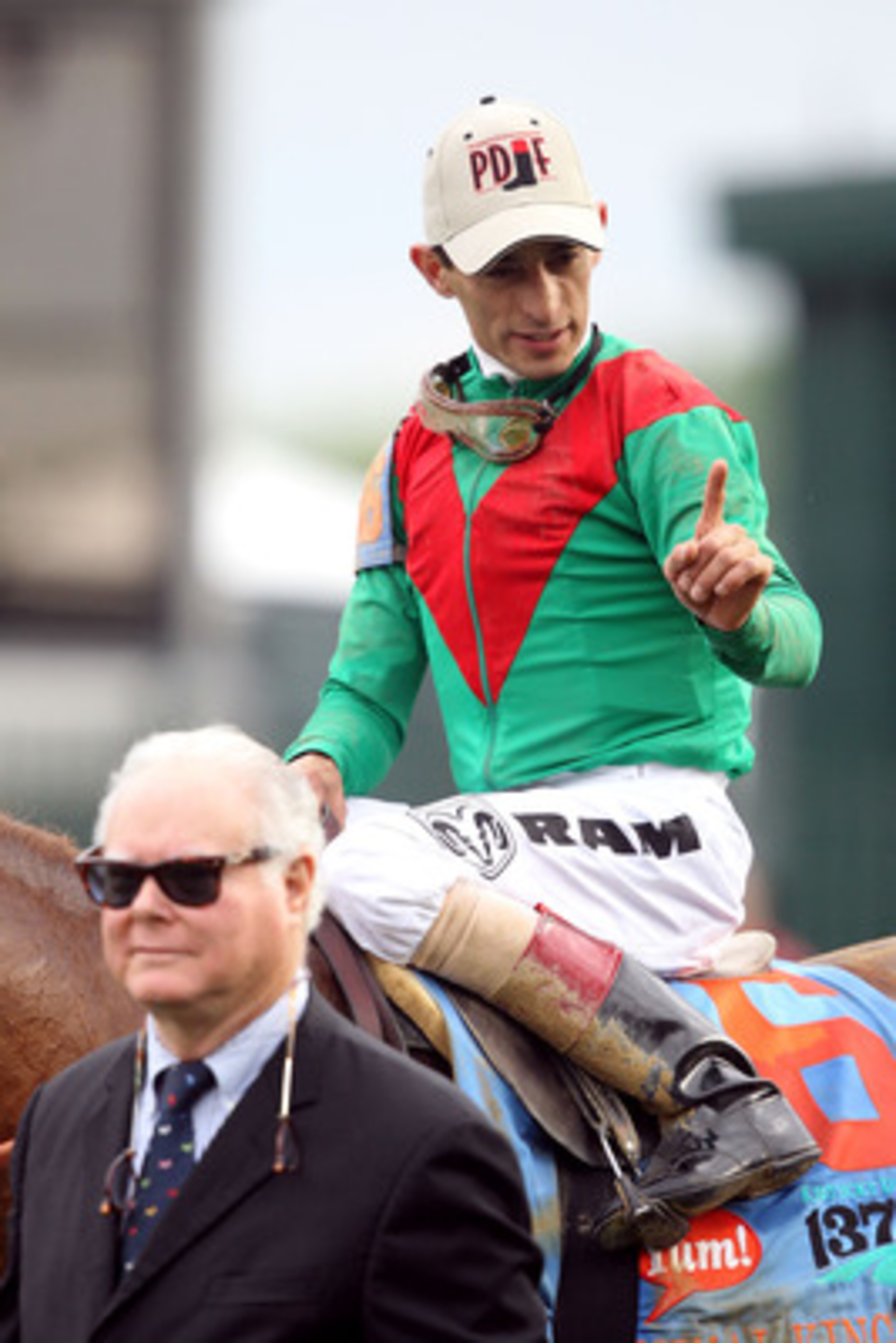 LOUISVILLE, KY - MAY 07:  Jockey John Velazquez, riding Animal Kingdom #16, celebrates as he he is lead to the winner's circle by owner Barry Irwin after winning the 137th Kentucky Derby at Churchill Downs on May 7, 2011 in Louisville, Kentucky.  (Photo b