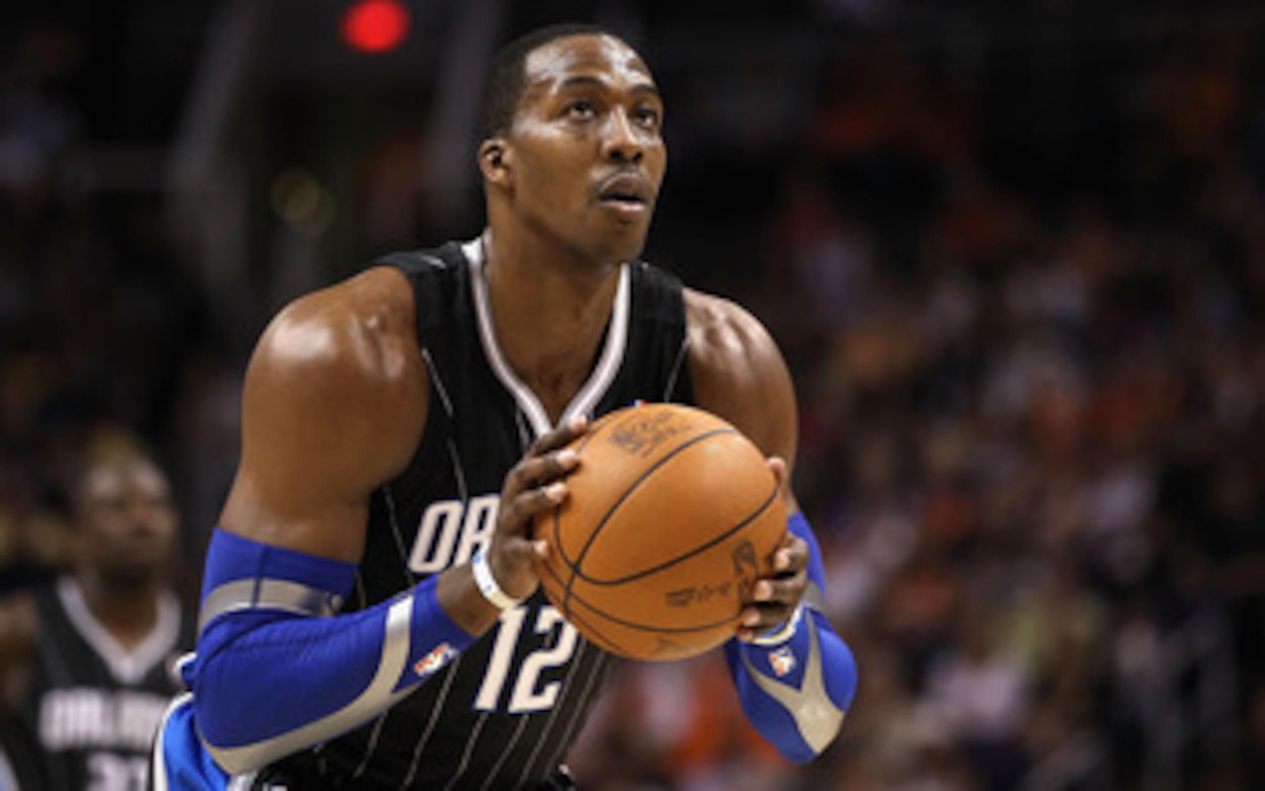 PHOENIX, AZ - MARCH 13:  Dwight Howard #12 of the Orlando Magic shoots a free throw shot against the Phoenix Suns during the NBA game at US Airways Center on March 13, 2011 in Phoenix, Arizona.  NOTE TO USER: User expressly acknowledges and agrees that, b