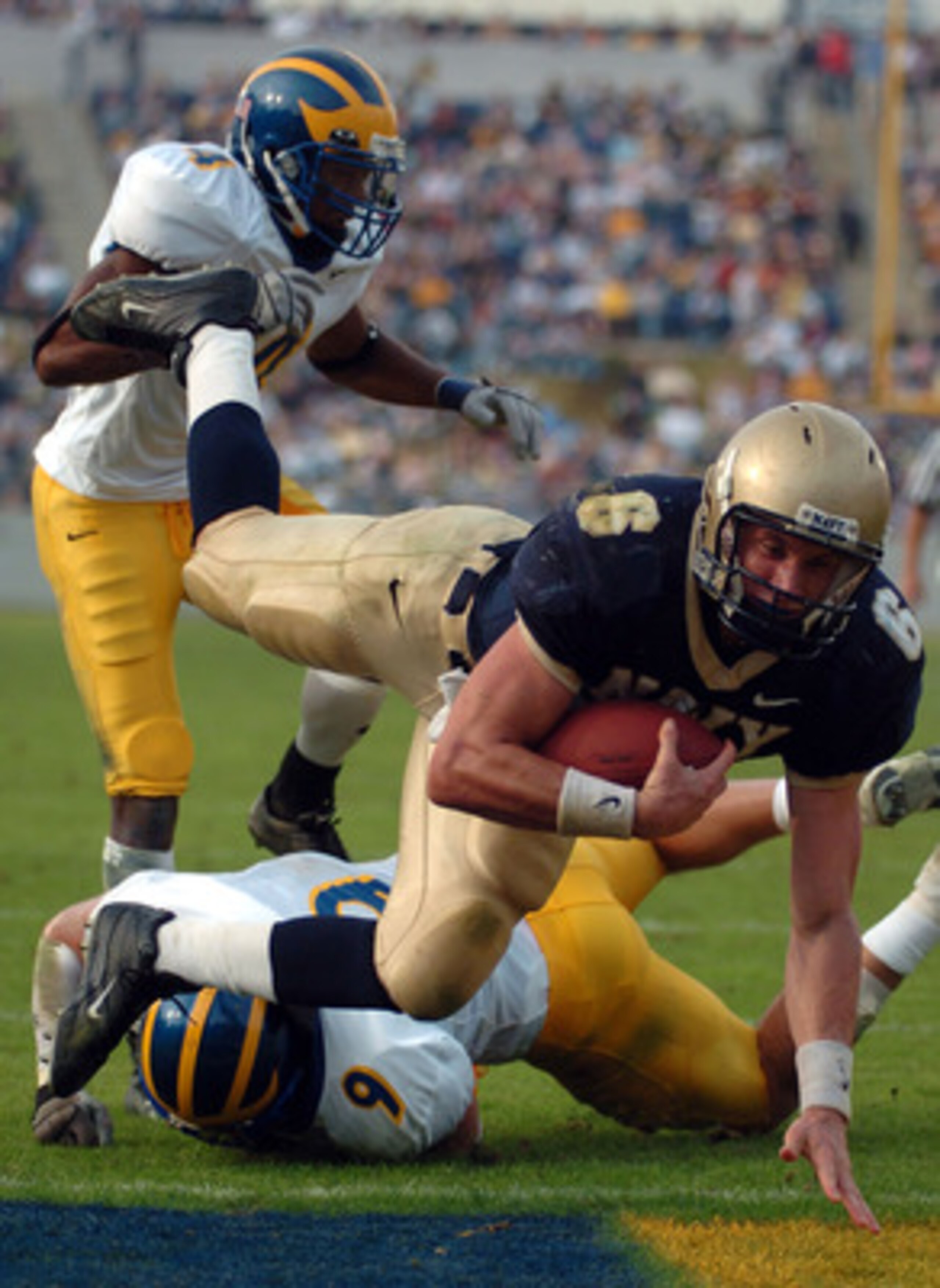 ANNAPOLIS, MD - OCTOBER 30:  In this handout from the U.S. Navy, United States Naval Academy Midshipman Quarterback Aaron Polanco #6 dives into the end zone for his second touchdown against the Delaware Blue Hens on October 30, 2004 at Navy-Marine Corps M