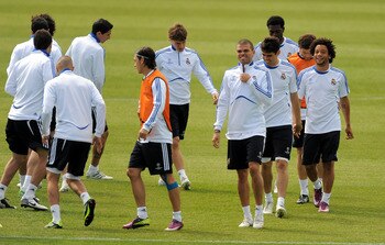MADRID, SPAIN - APRIL 26:  Mesut Ozil (C) of Real Madrid warms up with Pepe (3rd L) Kaka and Marcelo (R) during a training session at Valdebebas training ground ahead of their UEFA Champions League semi-final first leg match against Barcelona on April 26,