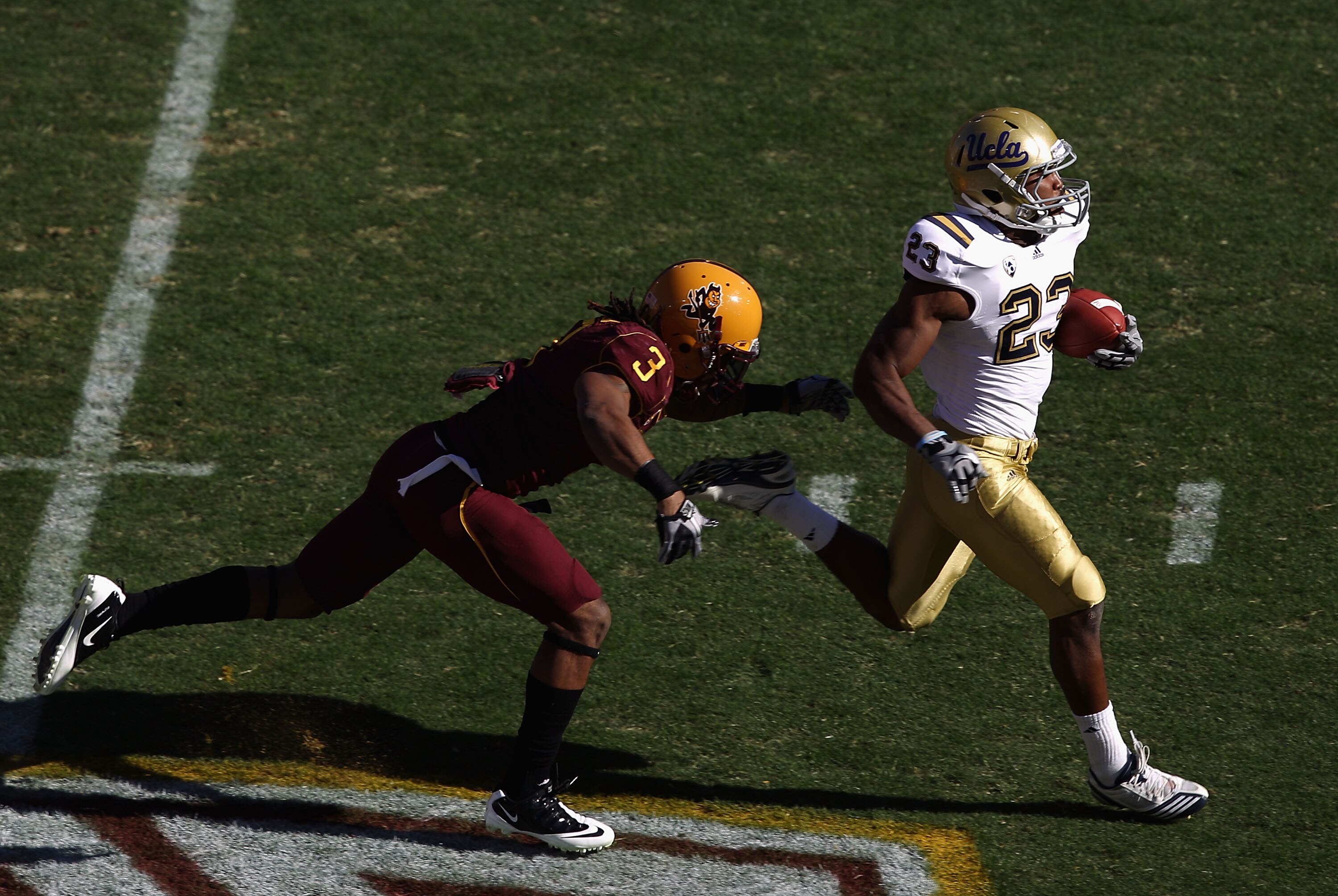 TEMPE, AZ - NOVEMBER 26:  Runningback Johnathan Franklin #23 of the UCLA Bruins carries the ball for a 55 yard rush past Omar Bolden #3 of the Arizona State Sun Devils during the first quarter of the college football game at Sun Devil Stadium on November