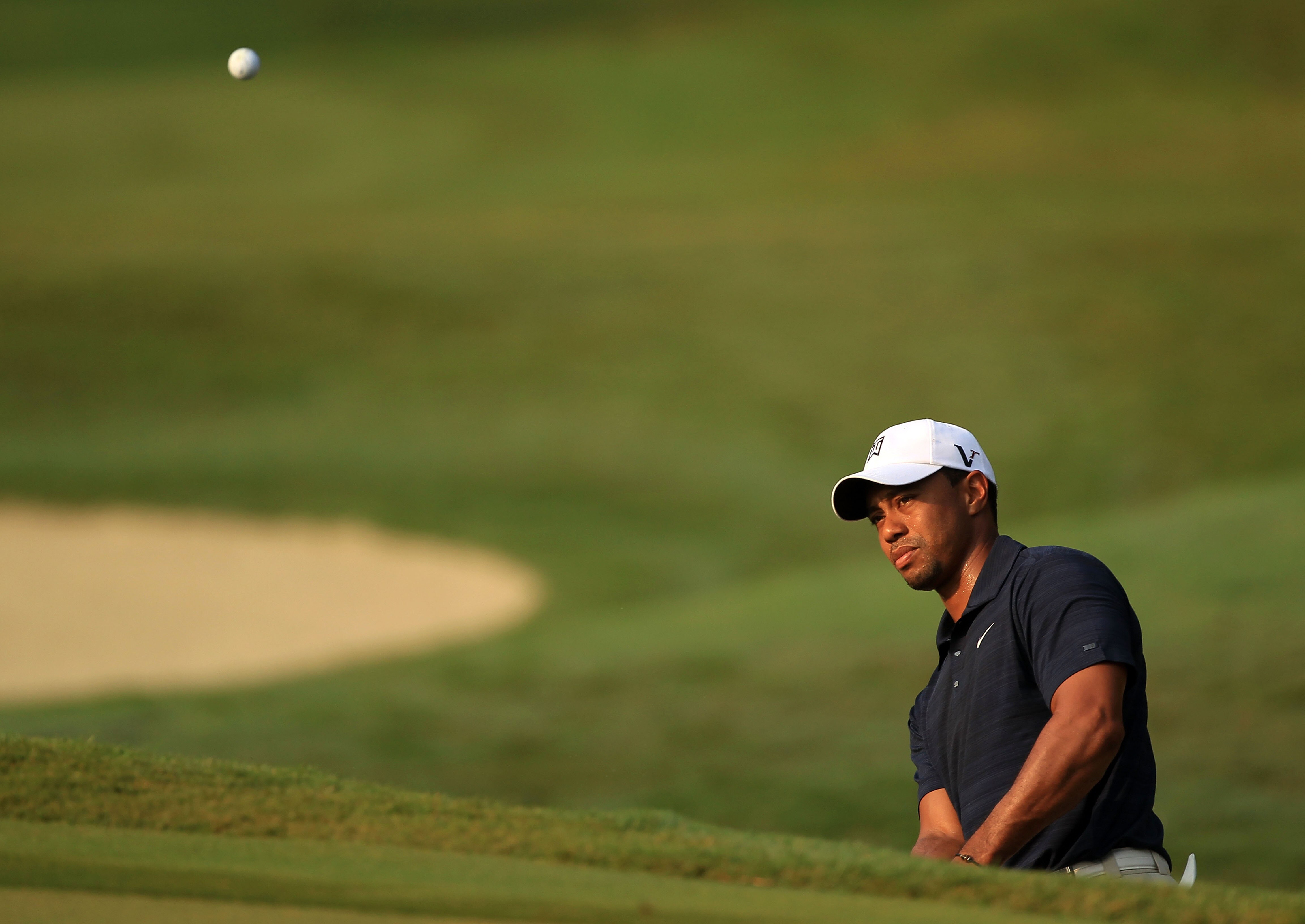 PONTE VEDRA BEACH, FL - MAY 12:  Tiger Woods hits a chip shot on the first hole during the first round of THE PLAYERS Championship held at THE PLAYERS Stadium course at TPC Sawgrass on May 12, 2011 in Ponte Vedra Beach, Florida.  (Photo by Streeter Lecka/