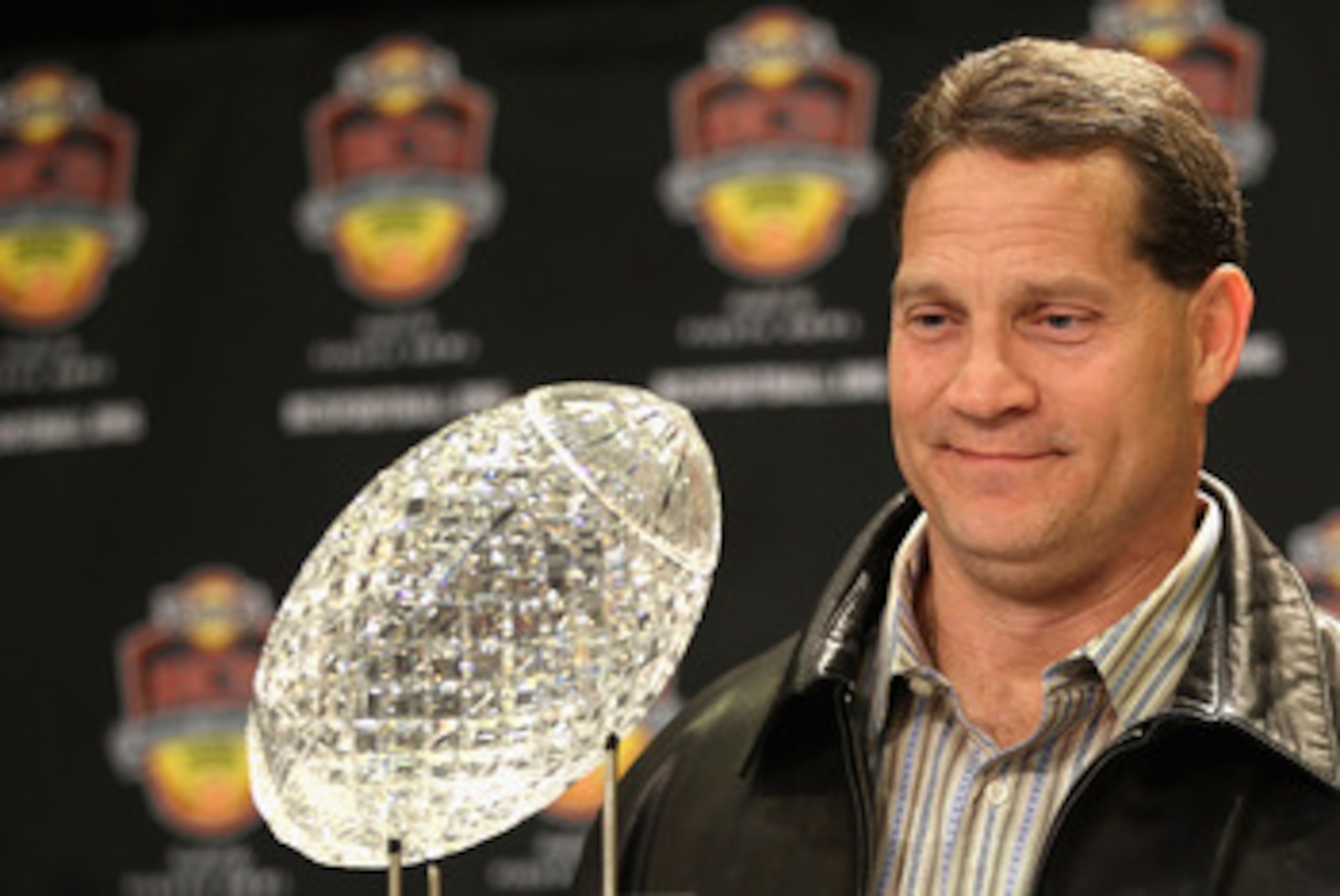 SCOTTSDALE, AZ - JANUARY 11:  Head coach Gene Chizik of the Auburn Tigers poses with the Coaches trophys during a press conference for the Tostitos BCS National Championship Game at the JW Marriott Camelback Inn on January 11, 2011 in Scottsdale, Arizona.