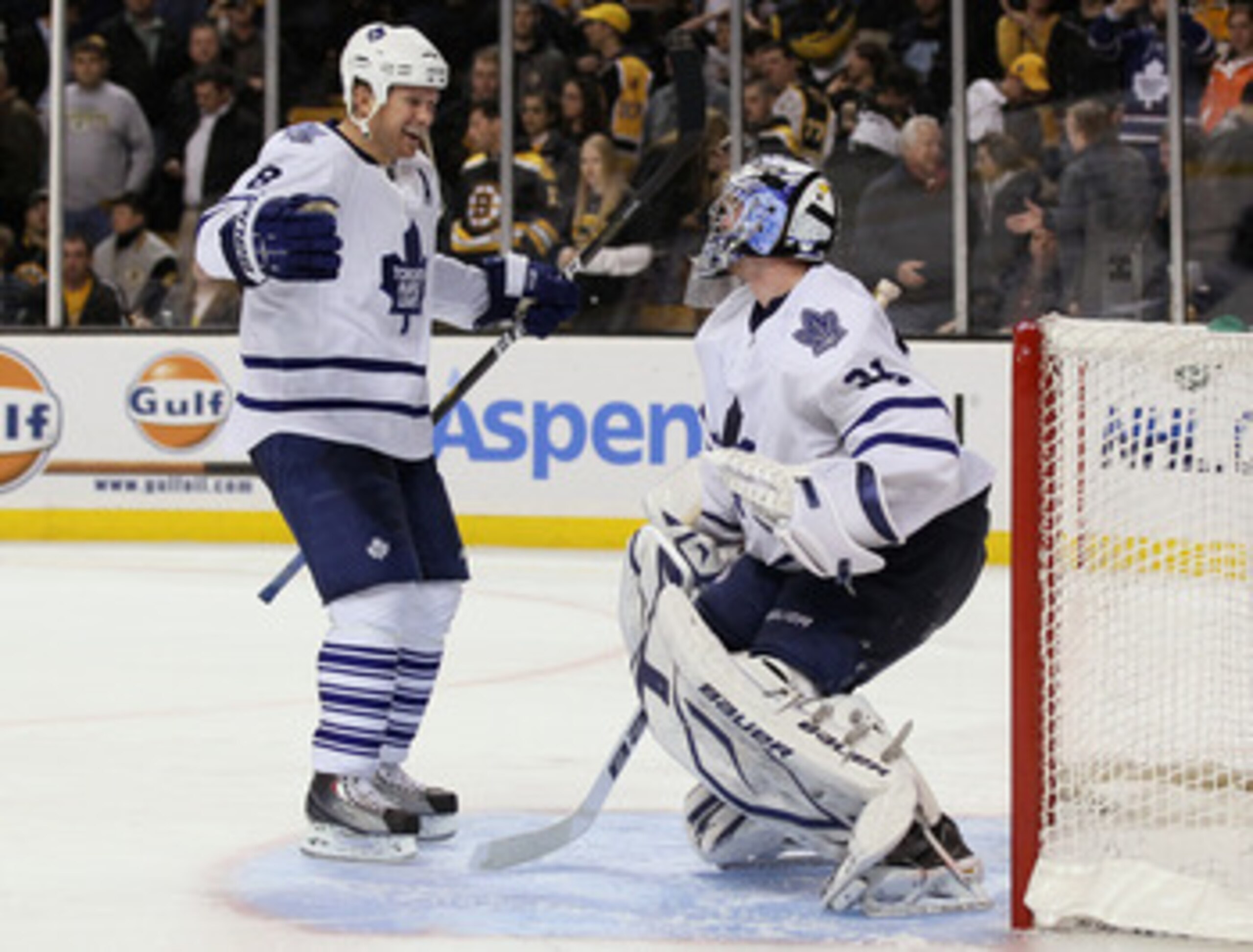 BOSTON, MA - MARCH 31: Mike Komisarek #8 of the Toronto Maple Leafs celebrates the win with teammate James Reimer #34 on March 31, 2011 at the TD Garden in Boston, Massachusetts. The Toronto Maple Leafs defeated the Boston Bruins 4-3 in an overtime shooto