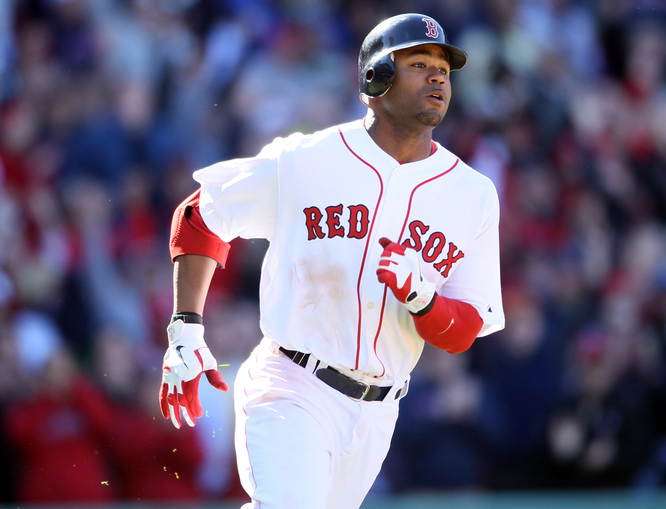 BOSTON, MA - MAY 01:  Carl Crawford #13 of the Boston Red Sox heads for first while Jed Lowrie scores the game winning run in the bottom of the ninth inning against the Seattle Mariners on May 1, 2011 at Fenway Park in Boston, Massachusetts. The Boston Re