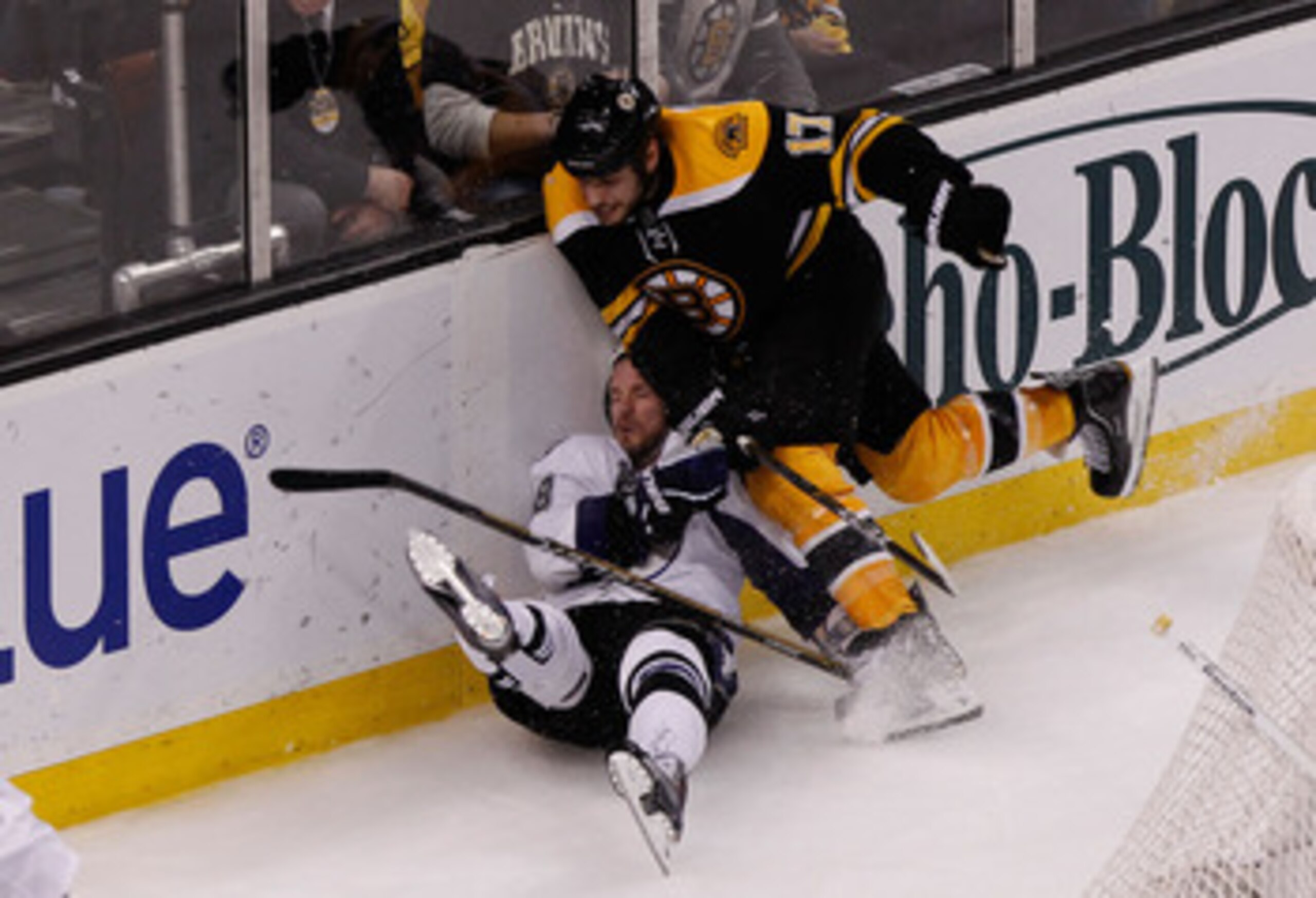 BOSTON, MA - MAY 14:  Adam Hall #18 of the Tampa Bay Lightning is checked by Milan Lucic #17 of the Boston Bruins in the third period of Game One of the Eastern Conference Finals during the 2011 NHL Stanley Cup Playoffs at TD Garden on May 14, 2011 in Bos