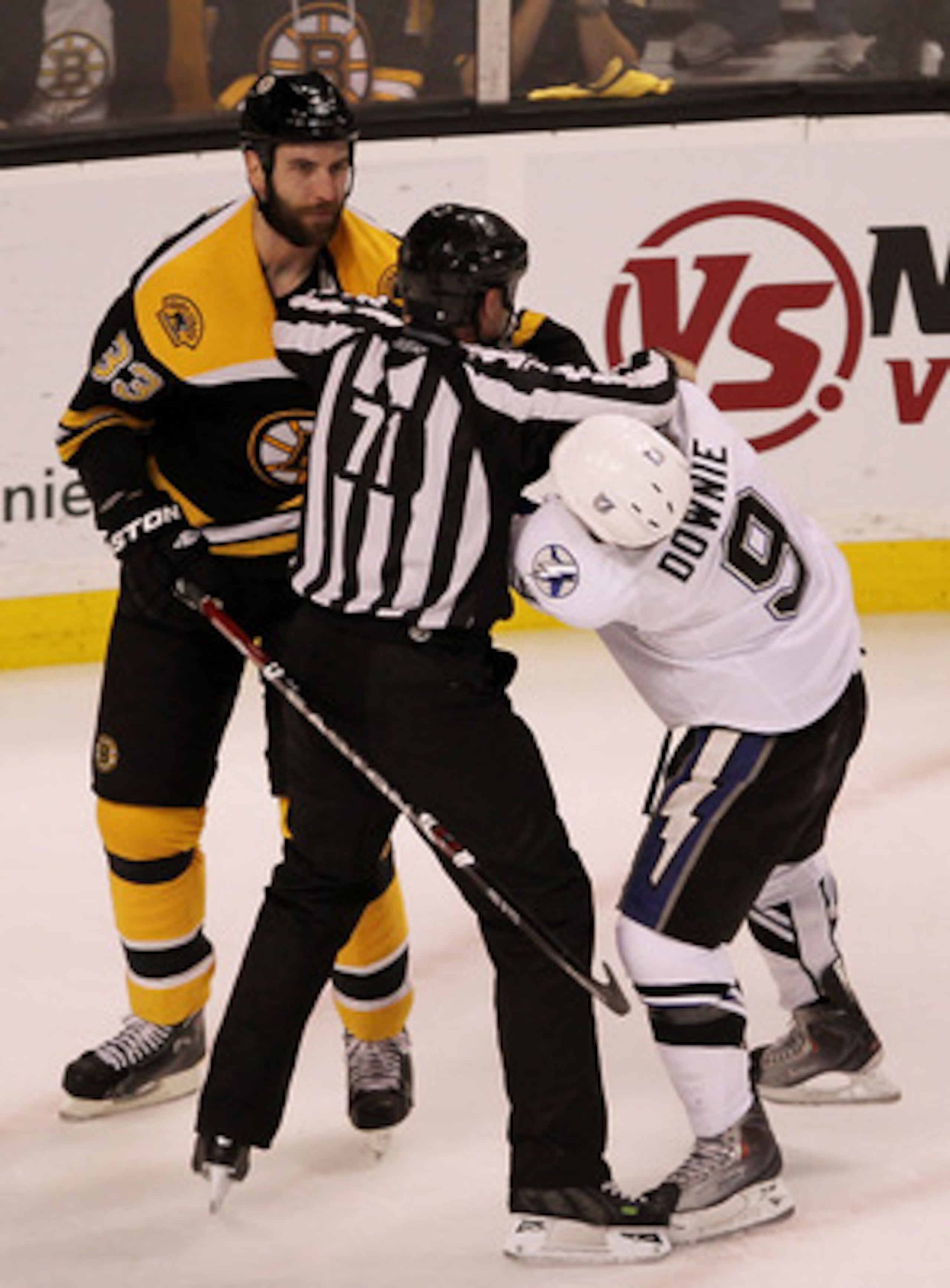 BOSTON, MA - MAY 17:  linesman Brad Kovachik #71 breaks up a fight between Zdeno Chara #33 of the Boston Bruins and Steve Downie #9 of the Tampa Bay Lightning in Game Two of the Eastern Conference Finals during the 2011 NHL Stanley Cup Playoffs at TD Gard