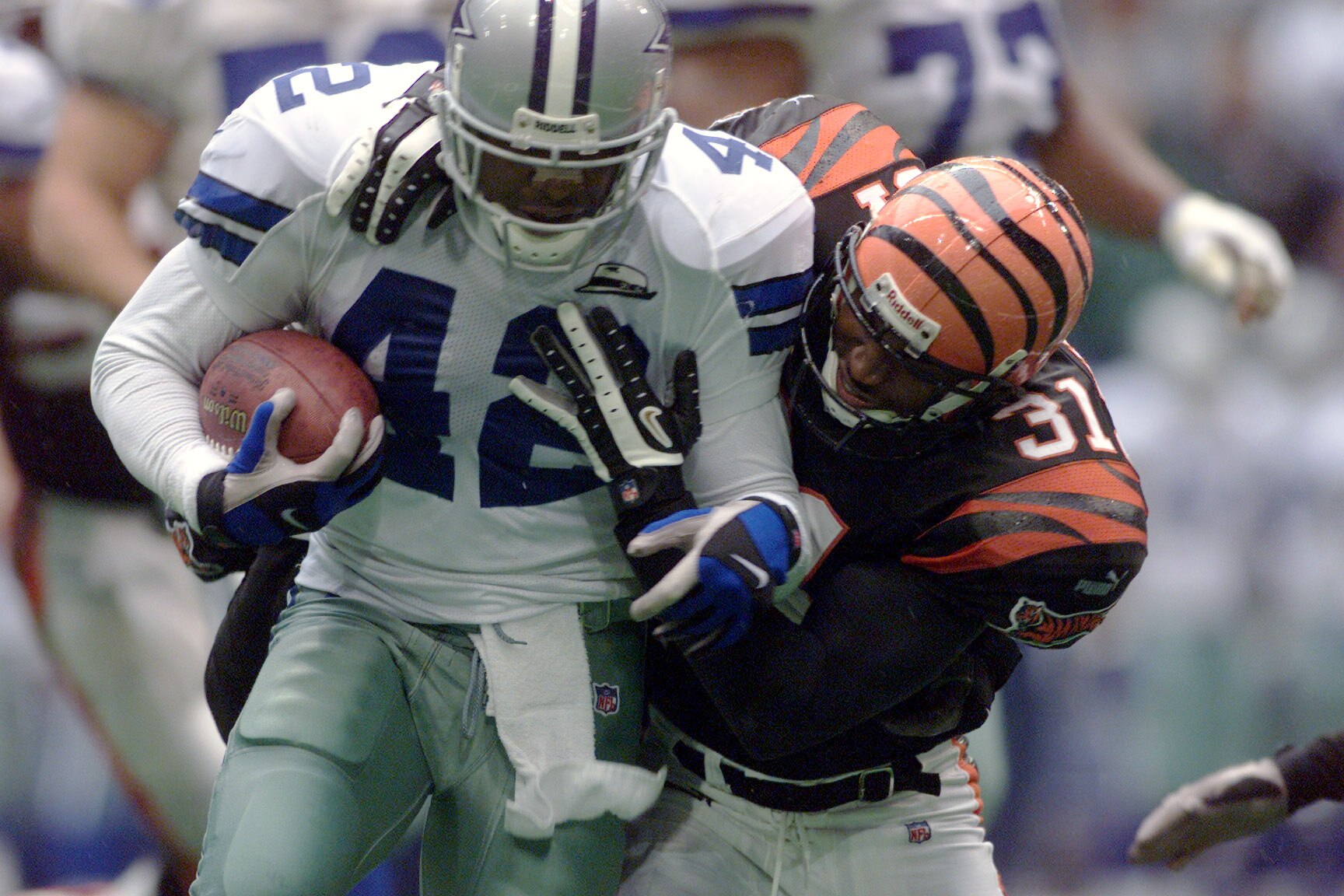 12 Nov 2000:  Running back Chris Warren #42 of the Dallas Cowboys is tackled by Darryl Williams #31 of the Cincinnati Bengals during Sunday's game at Texas Stadium in Irving, Texas. DIGITAL IMAGE. Mandatory Credit: Jamie Squire/ALLSPORT