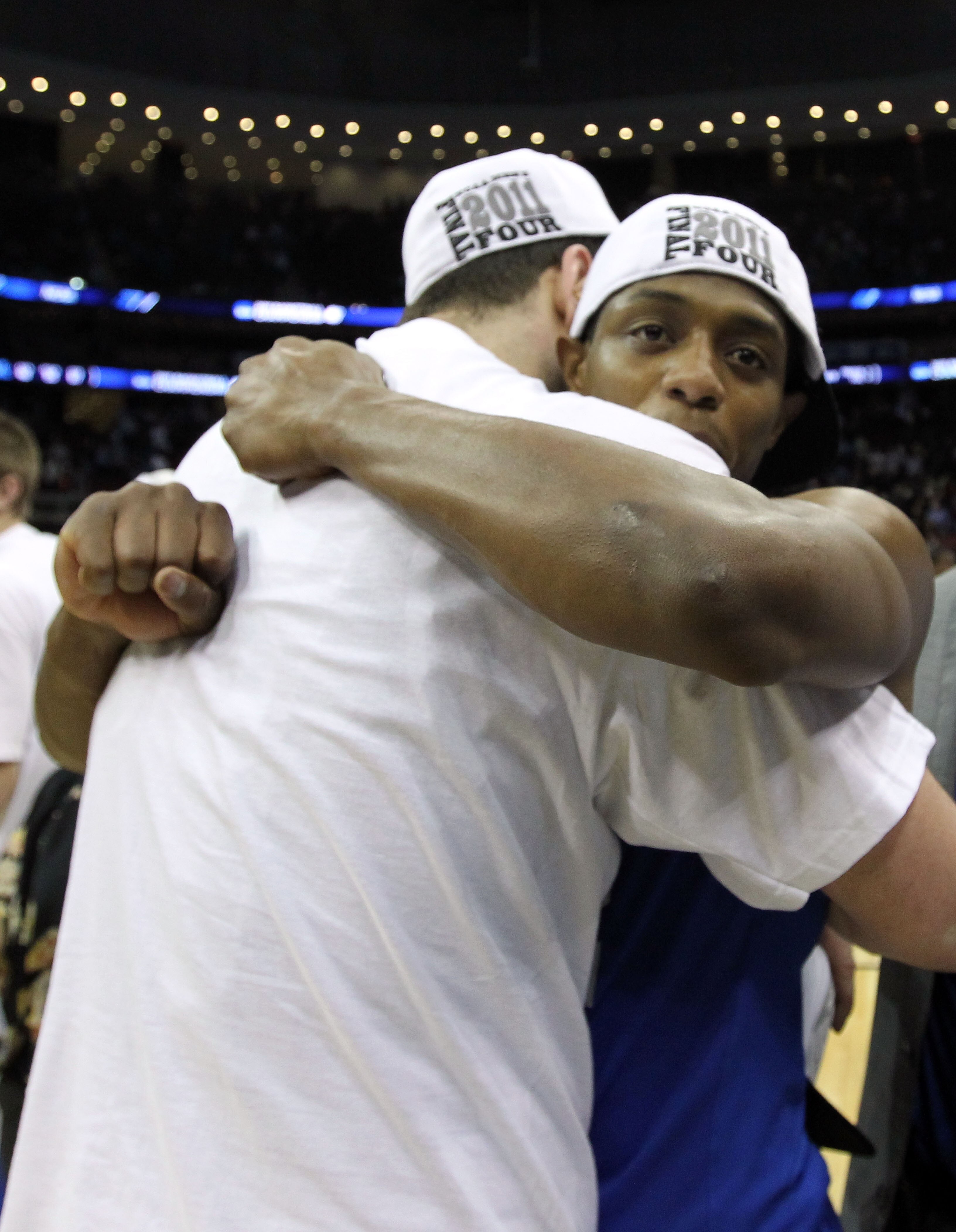 NEWARK, NJ - MARCH 27:  Josh Harrellson #55 of the Kentucky Wildcats hugs tammate Brandon Knight #12 of the Kentucky Wildcats after defeating the North Carolina Tar Heels in the east regional final of the 2011 NCAA men's basketball tournament at Prudentia