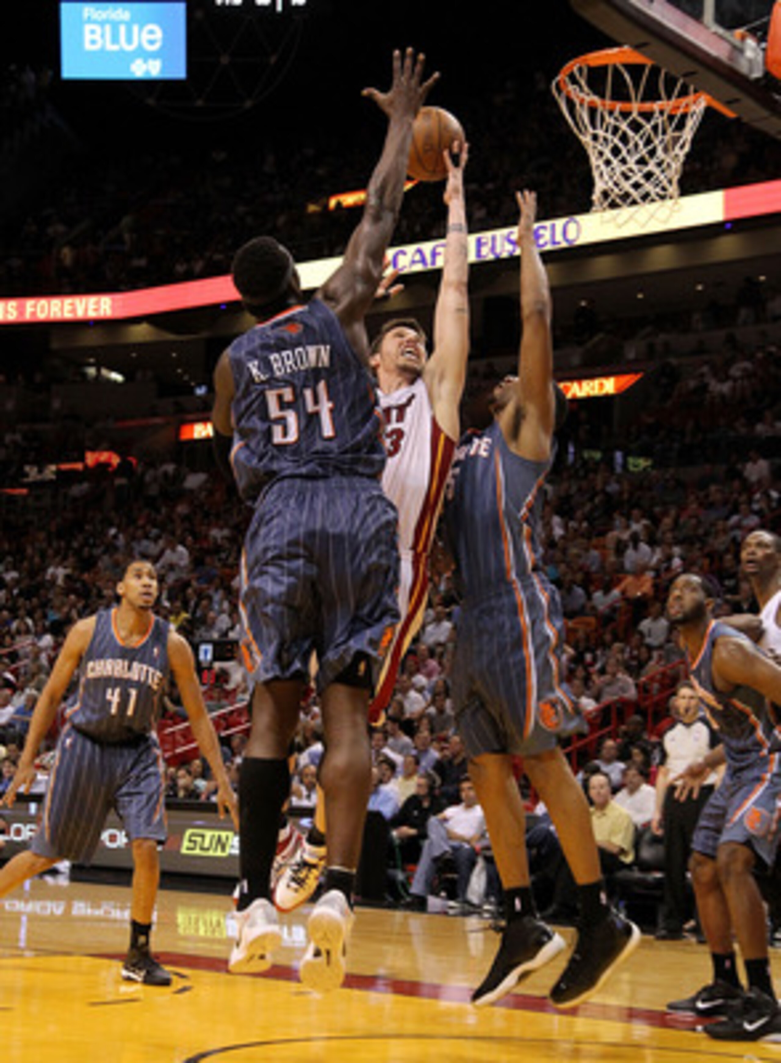 MIAMI, FL - APRIL 08:  Mike Miller #13 of the Miami Heat drives against Kwame Brown #54 and Dominic McGuire #5 of the Charlotte Bobcats during a game at American Airlines Arena on April 8, 2011 in Miami, Florida. NOTE TO USER: User expressly acknowledges 