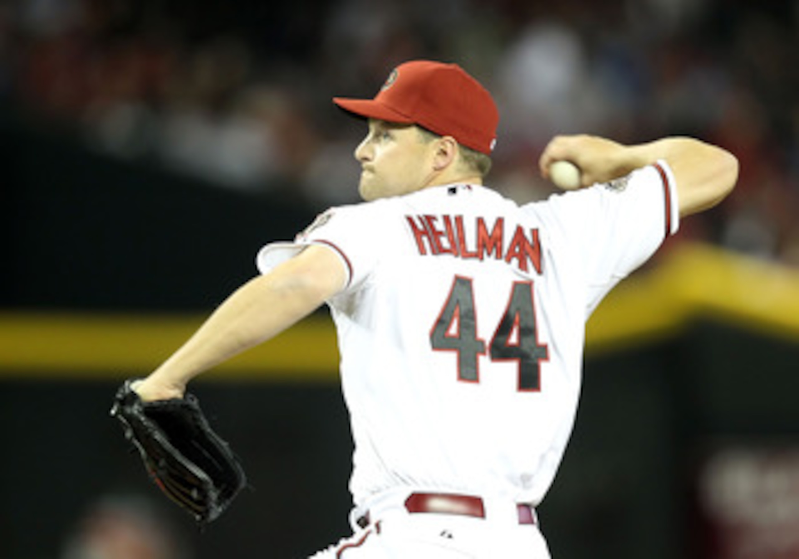 PHOENIX, AZ - APRIL 08:  Relief pitcher Aaron Heilman #44 of the Arizona Diamondbacks pitches against the Cincinnati Reds during the Major League Baseball home opening game at Chase Field on April 8, 2011 in Phoenix, Arizona.  The Diamondbacks defeated th