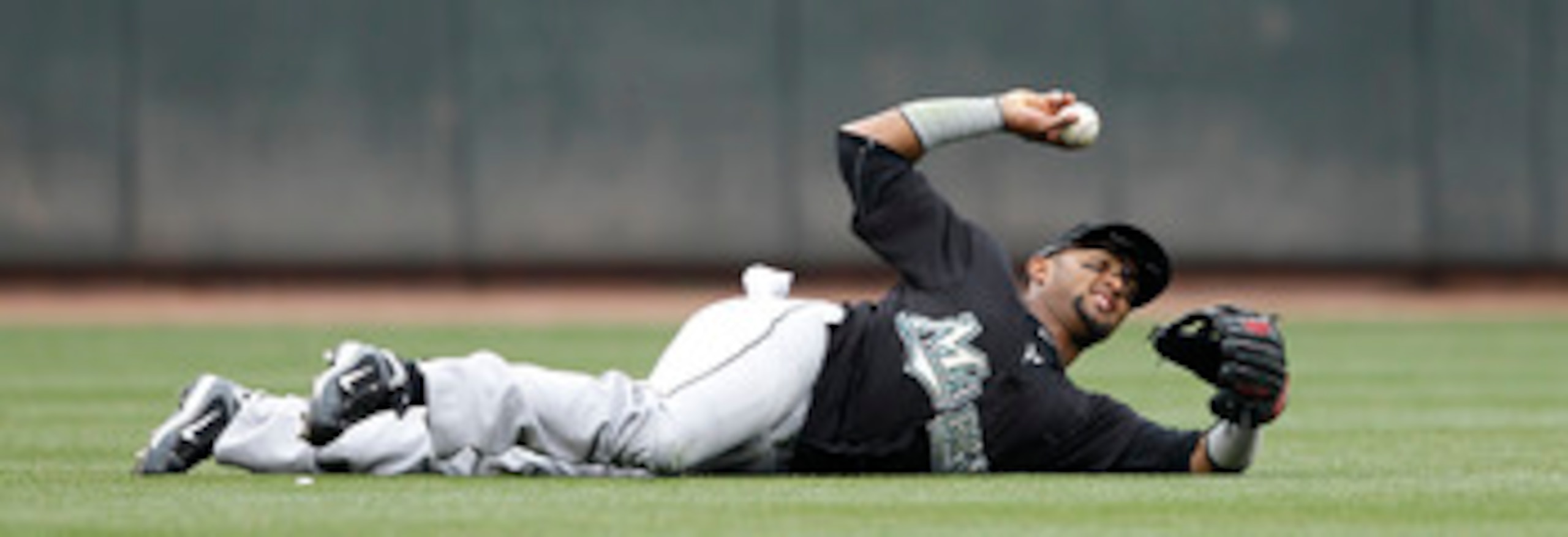 CINCINNATI, OH - MAY 1: Emilio Bonifacio #1 of the Florida Marlins throws the ball after making a diving catch against the Cincinnati Reds at Great American Ball Park on May 1, 2011 in Cincinnati, Ohio. The Marlins defeated the Reds 9-5. (Photo by Joe Rob