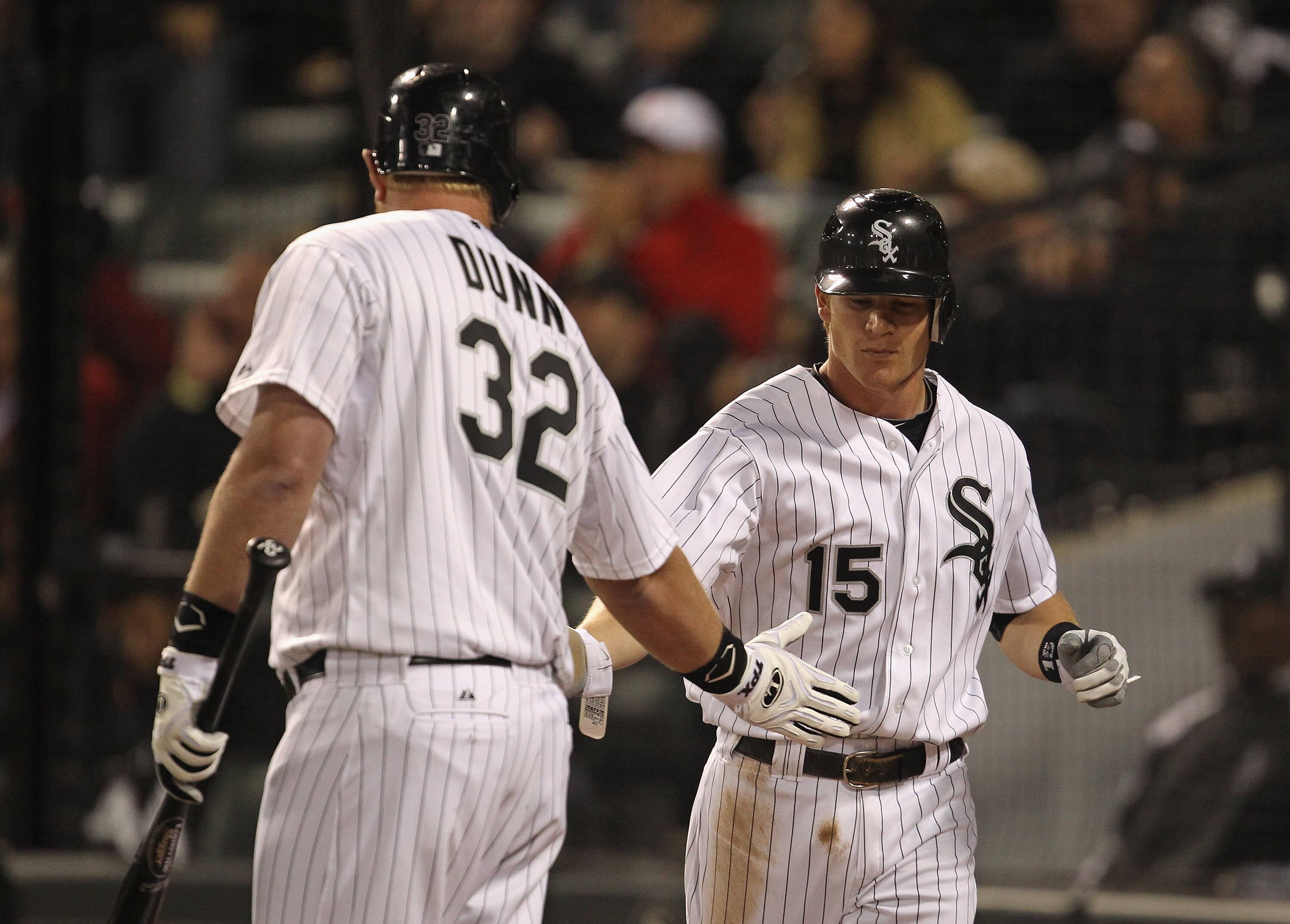 CHICAGO, IL - MAY 17: Gordon Beckham #15 of the Chicago White Sox is congratulated by teammate Adam Dunn #32 after scoring the game-winning run in the 8th inning on a wild pitch against the Texas Rangers at U.S. Cellular Field on May 17, 2011 in Chicago, CHICAGO, IL - MAY 17: Gordon Beckham #15 of the Chicago White Sox is congratulated by teammate Adam Dunn #32 after scoring the game-winning run in the 8th inning on a wild pitch against the Texas Rangers at U.S. Cellular Field on May 17, 2011 in Chicago,