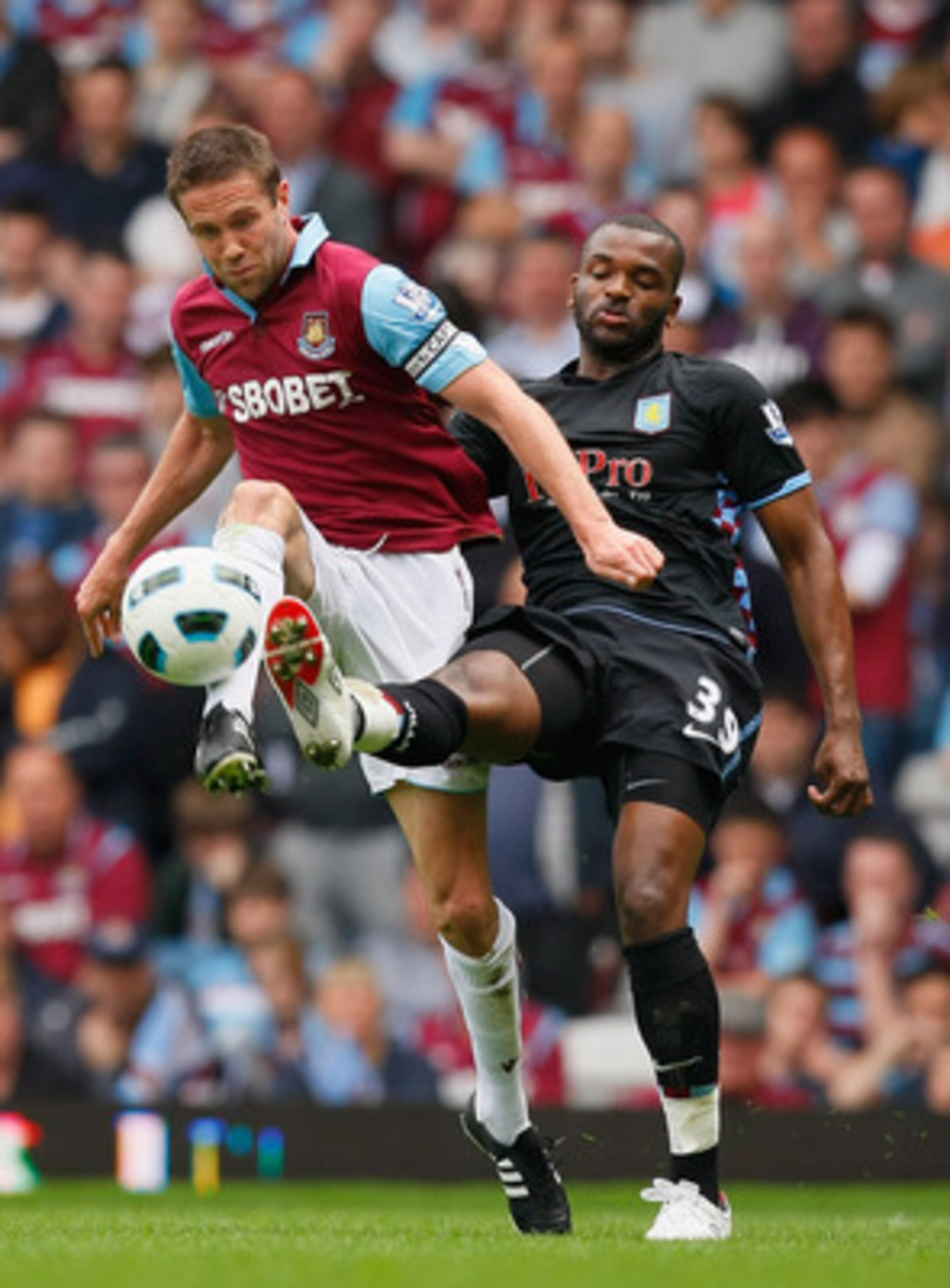 LONDON, ENGLAND - APRIL 16:  Matthew Upson of West Ham United and Darren Bent of Aston Villa battle for the ball during the Barclays Premier League match between West Ham United and Aston Villa at the Boleyn Ground on April 16, 2011 in London, England.  (