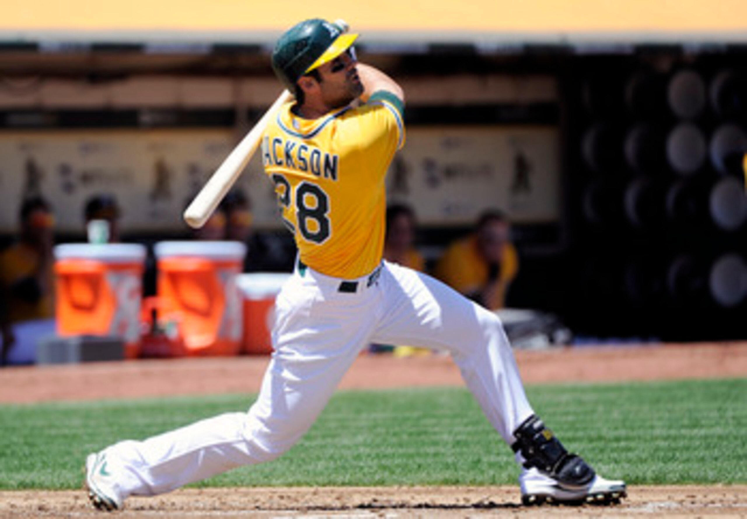 OAKLAND, CA - MAY 1: Conor Jackson #28 of the Oakland Athletics hits a double to drive in two runs in the bottom of the first inning against the Texas Rangers during a MLB baseball game at the Oakland-Alameda County Coliseum May 1, 2011 in Oakland, Califo