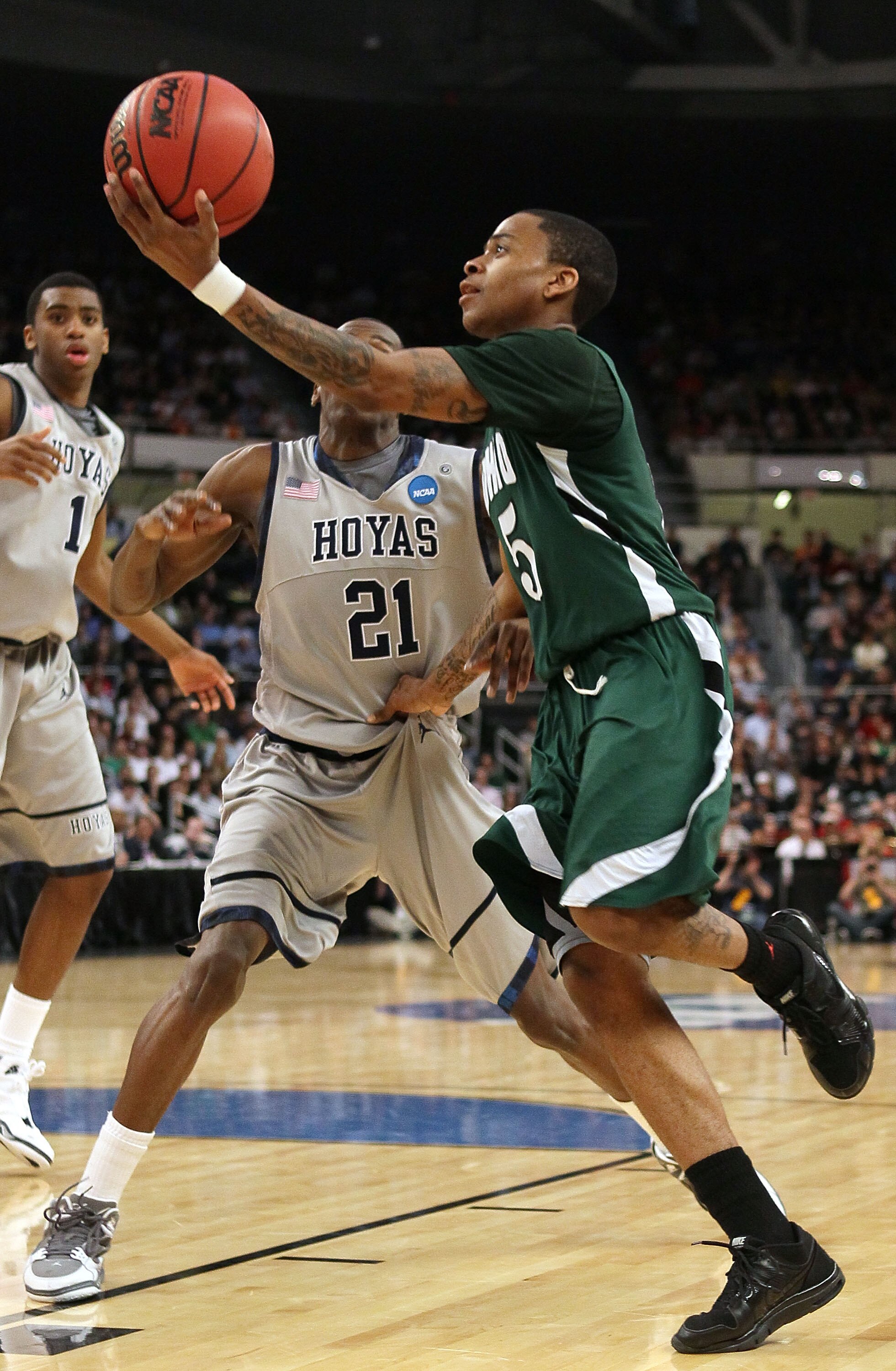 PROVIDENCE, RI - MARCH 18:  D.J. Cooper #5 of the Ohio Bobcats heads for the net as Jason Clark #21 of the Georgetown Hoyas defends during the first round of the 2010 NCAA men's basketball tournament on March 18, 2010 at the Dunkin Donuts Arena in Provide
