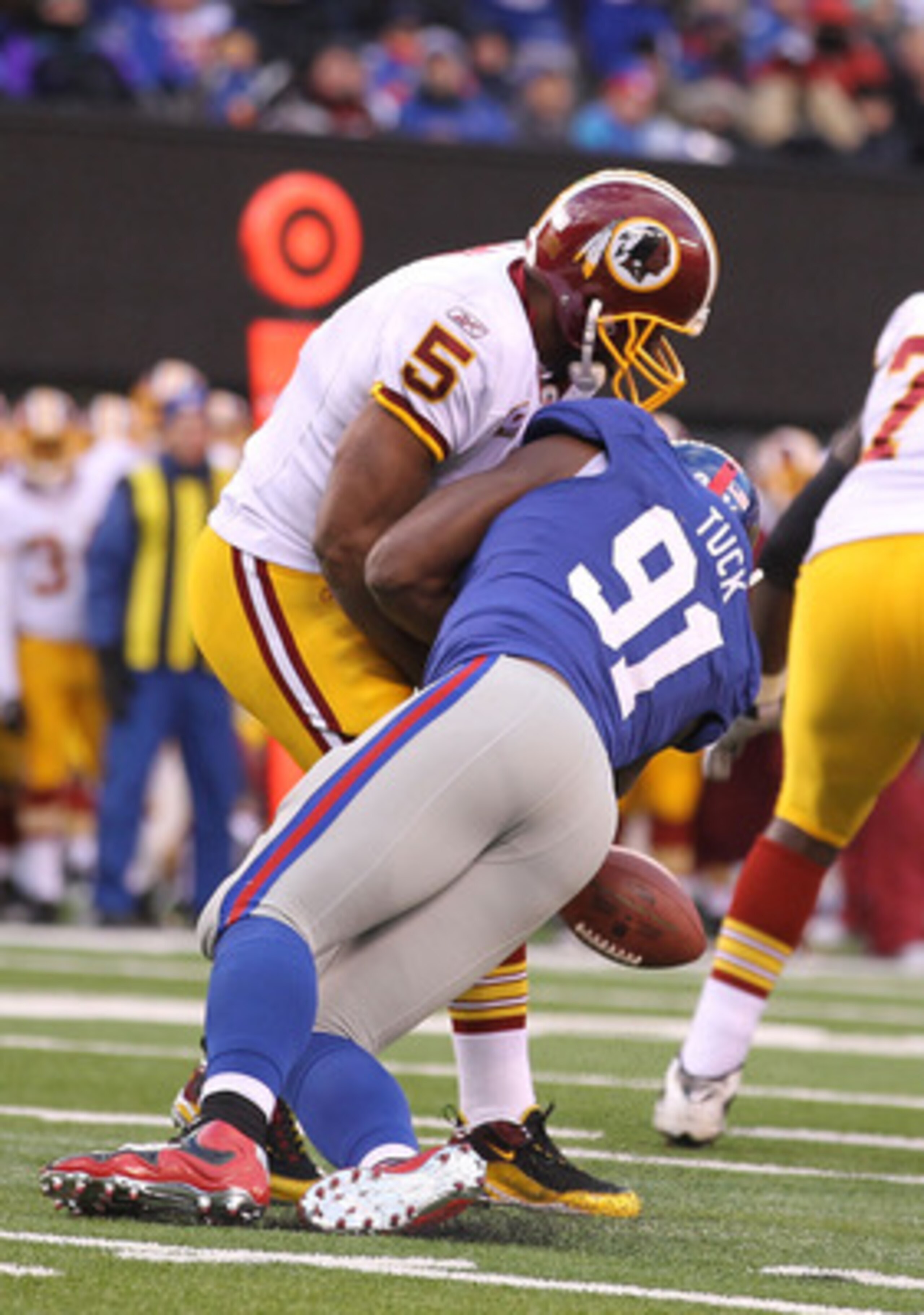 EAST RUTHERFORD, NJ - DECEMBER 05:  Justin Tuck #91 of the New York Giants sacks Donovan McNabb #5 of the Washington Redskins who fumbles and loses the ball during their game on December 5, 2010 at The New Meadowlands Stadium in East Rutherford, New Jerse