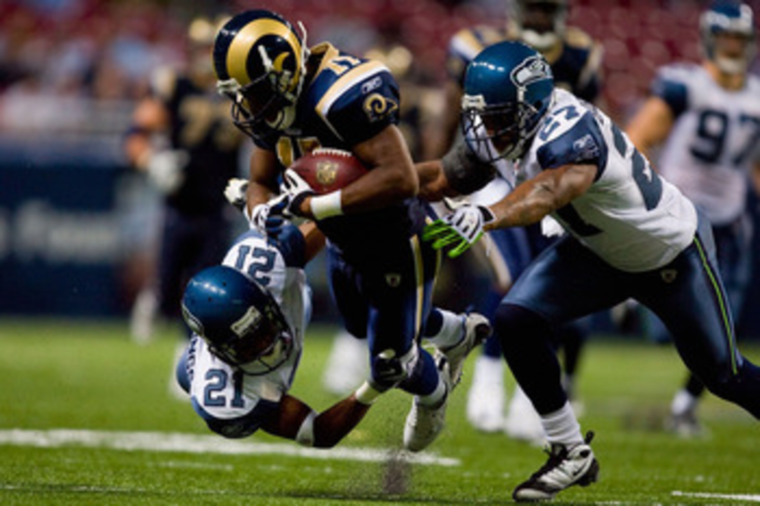 ST. LOUIS - NOVEMBER 29:  Donnie Avery #17 of the St. Louis Rams is tackled by Kelly Jennings #21 and Jordan Babineaux #27 both of the Seattle Seahawks at the Edward Jones Dome on November 29, 2009 in St. Louis, Missouri.  (Photo by Dilip Vishwanat/Getty 