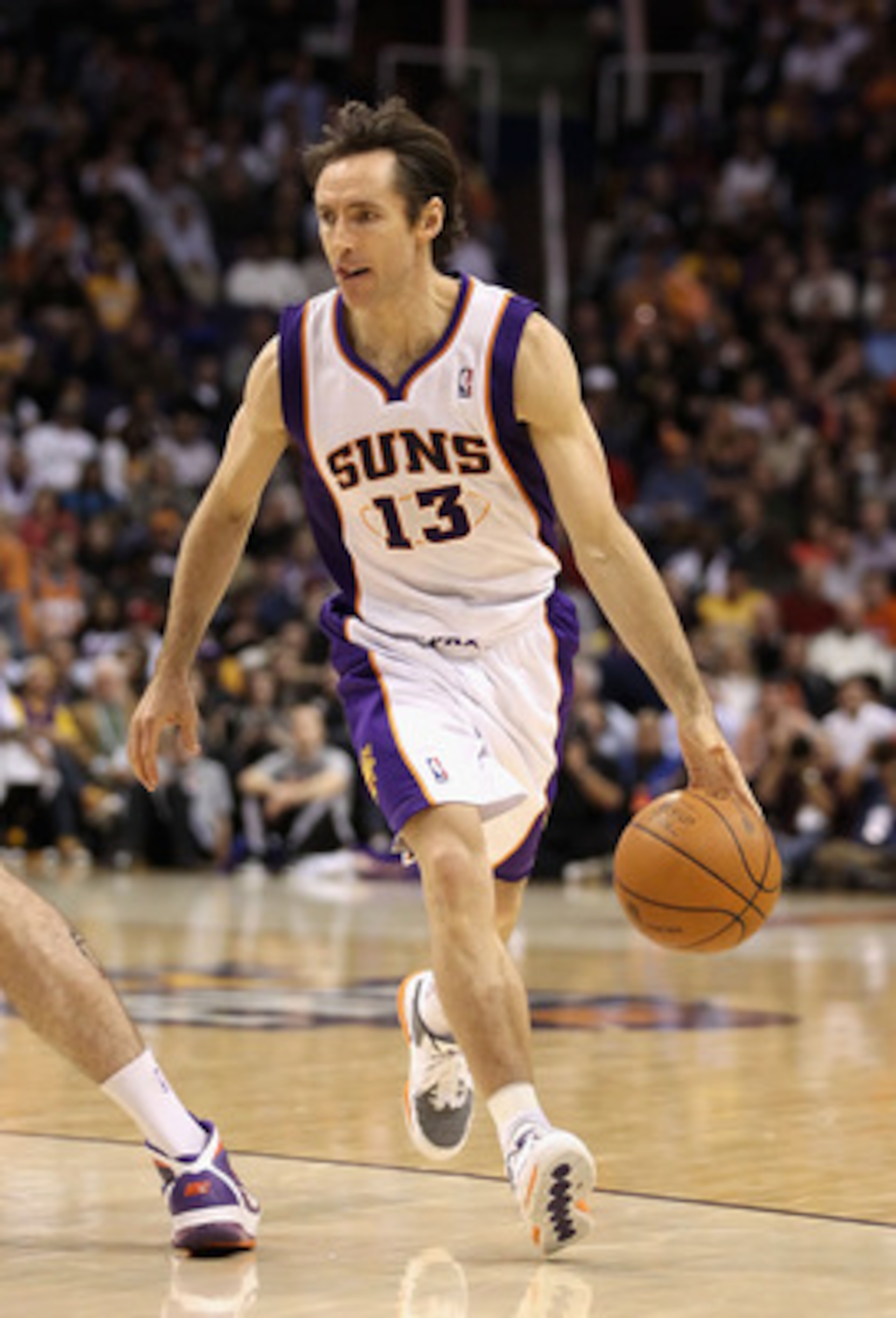 PHOENIX, AZ - JANUARY 05:  Steve Nash #13 of the Phoenix Suns handles the ball during the NBA game against the Los Angeles Lakers at US Airways Center on January 5, 2011 in Phoenix, Arizona. The Lakers defeated the Suns 99-95.  NOTE TO USER: User expressl