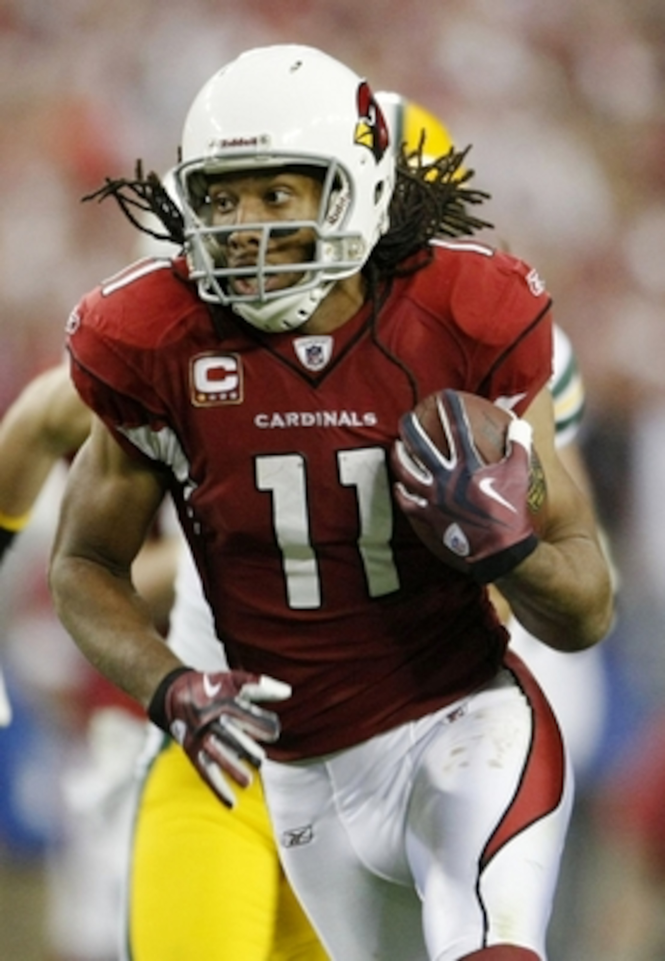 GLENDALE, AZ - JANUARY 10:  Wide receiver Larry Fitzgerald #11 of the Arizona Cardinals runs for a touchdown in the third quarter of the 2010 NFC wild-card playoff game against the Green Bay Packers at University of Phoenix Stadium on January 10, 2010 in 
