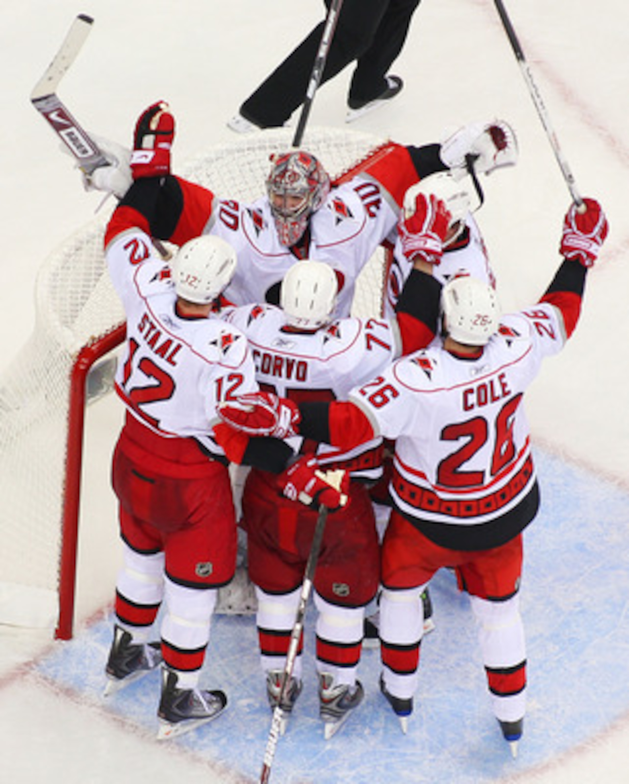 NEWARK, NJ - APRIL 28:  Cam Ward #30 of the Carolina Hurricanes celebrates with teammates Eric Staal #12, Erik Cole #28 and Joe Corvo #77 after defeating the New Jersey Devils 4-3 in Game Seven of the Eastern Conference Quarterfinal Round of the 2009 Stan