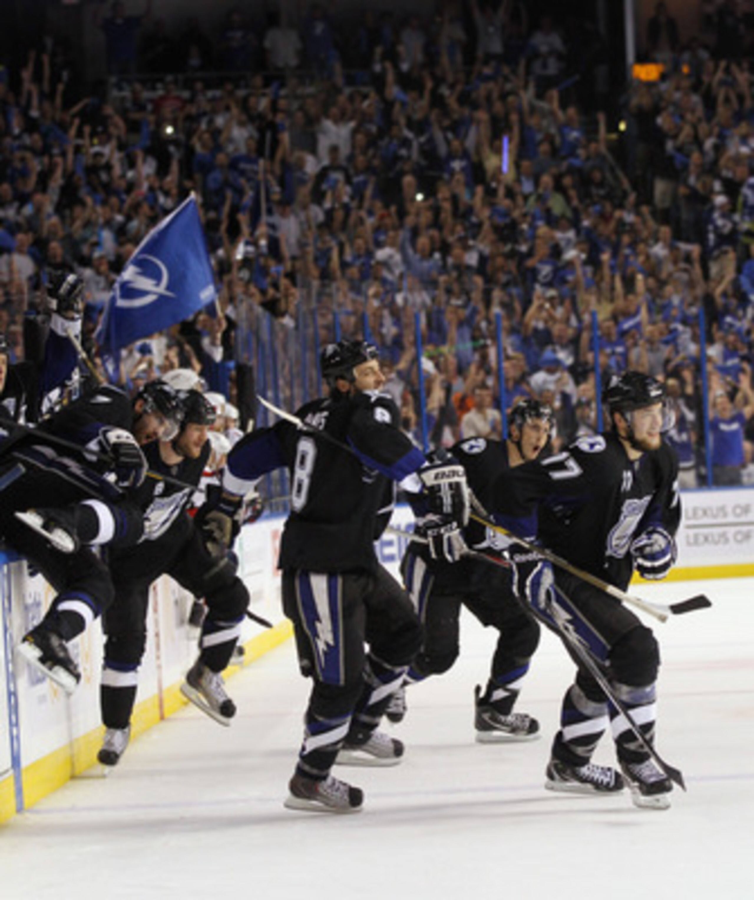 TAMPA, FL - MAY 04:  Randy Jones #8, Victor Hedman #77, and the Tampa Bay Lightning celebrate their 5-3 victory over the Washington Capitals in Game Four of the Eastern Conference Semifinals during the 2011 NHL Stanley Cup Playoffs at the St Pete Times Fo