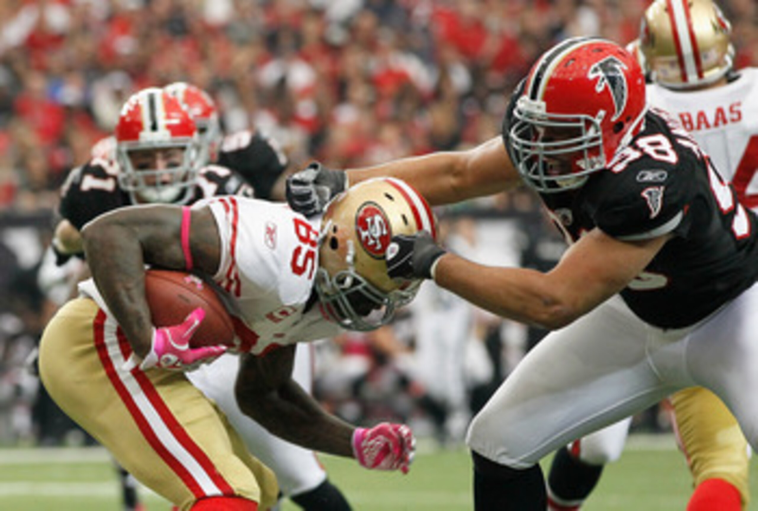 ATLANTA - OCTOBER 03:  Jamaal Anderson #98 of the Atlanta Falcons tackles Vernon Davis #85 of the San Francisco 49ers at Georgia Dome on October 3, 2010 in Atlanta, Georgia.  (Photo by Kevin C. Cox/Getty Images)