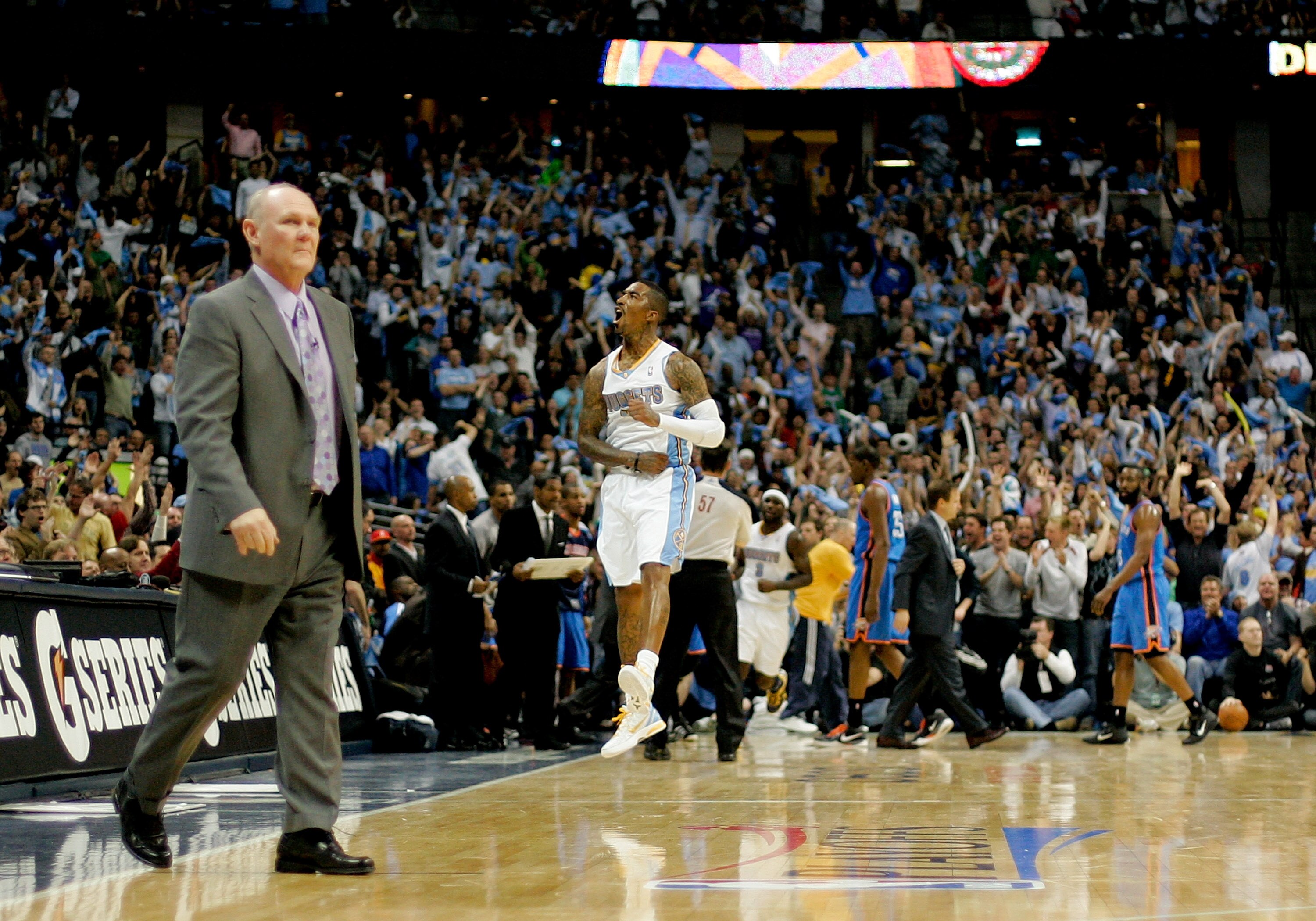 DENVER, CO - APRIL 25:  J.R. Smith #5 of the Denver Nuggets celebrates a three point basket as head coach George Karl walks onto the court for a timeout against the Oklahoma City Thunder in Game Four of the Western Conference Quarterfinals in the 2011 NBA