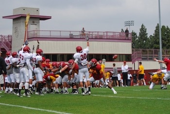 PK Andre Heidari kicking against broomsticks in spring practice