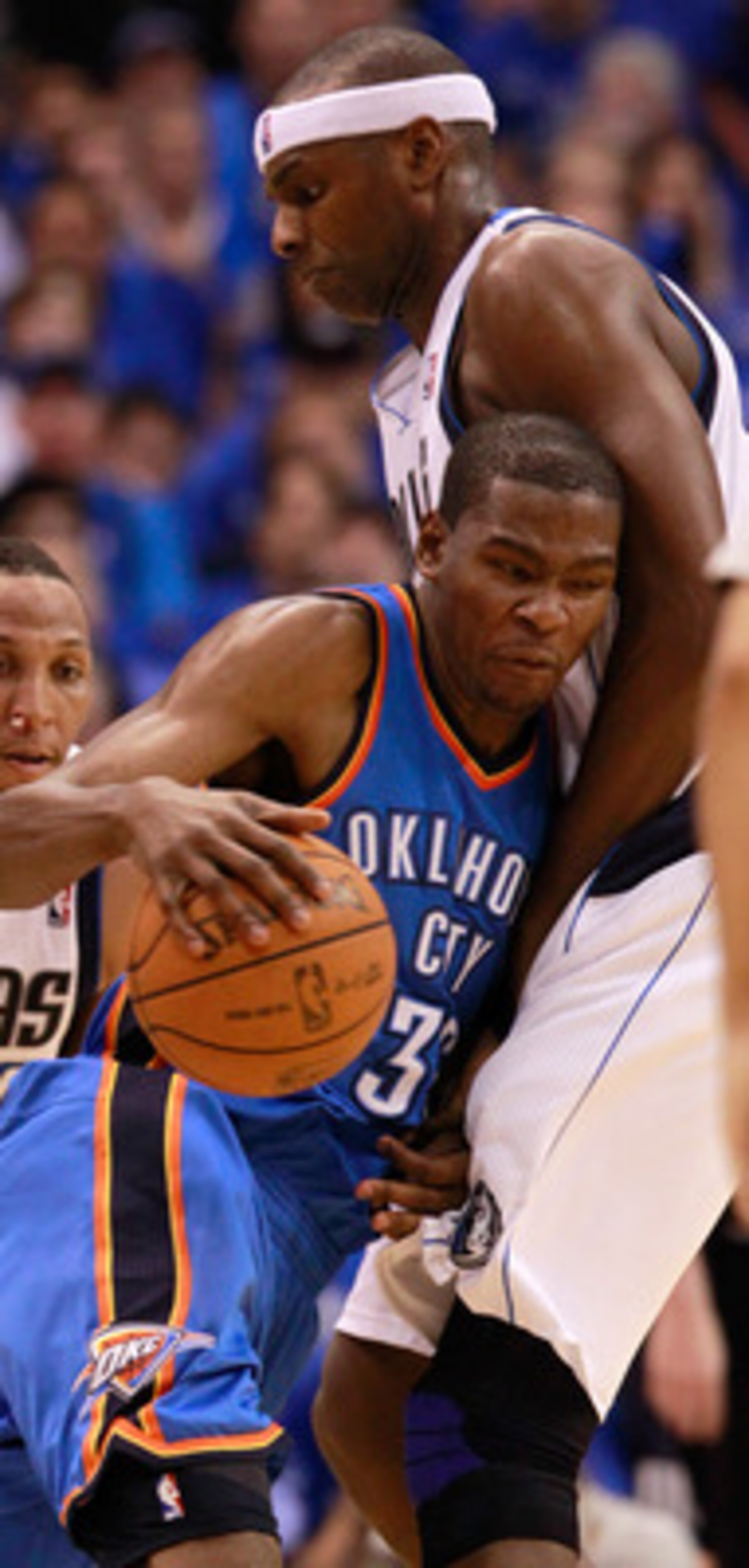 DALLAS, TX - MAY 17:  Kevin Durant #35 of the Oklahoma City Thunder moves the ball into Brendan Haywood #33 of the Dallas Mavericks as Shawn Marion #0 of the Mavericks is behind Durant in the second half in Game One of the Western Conference Finals during