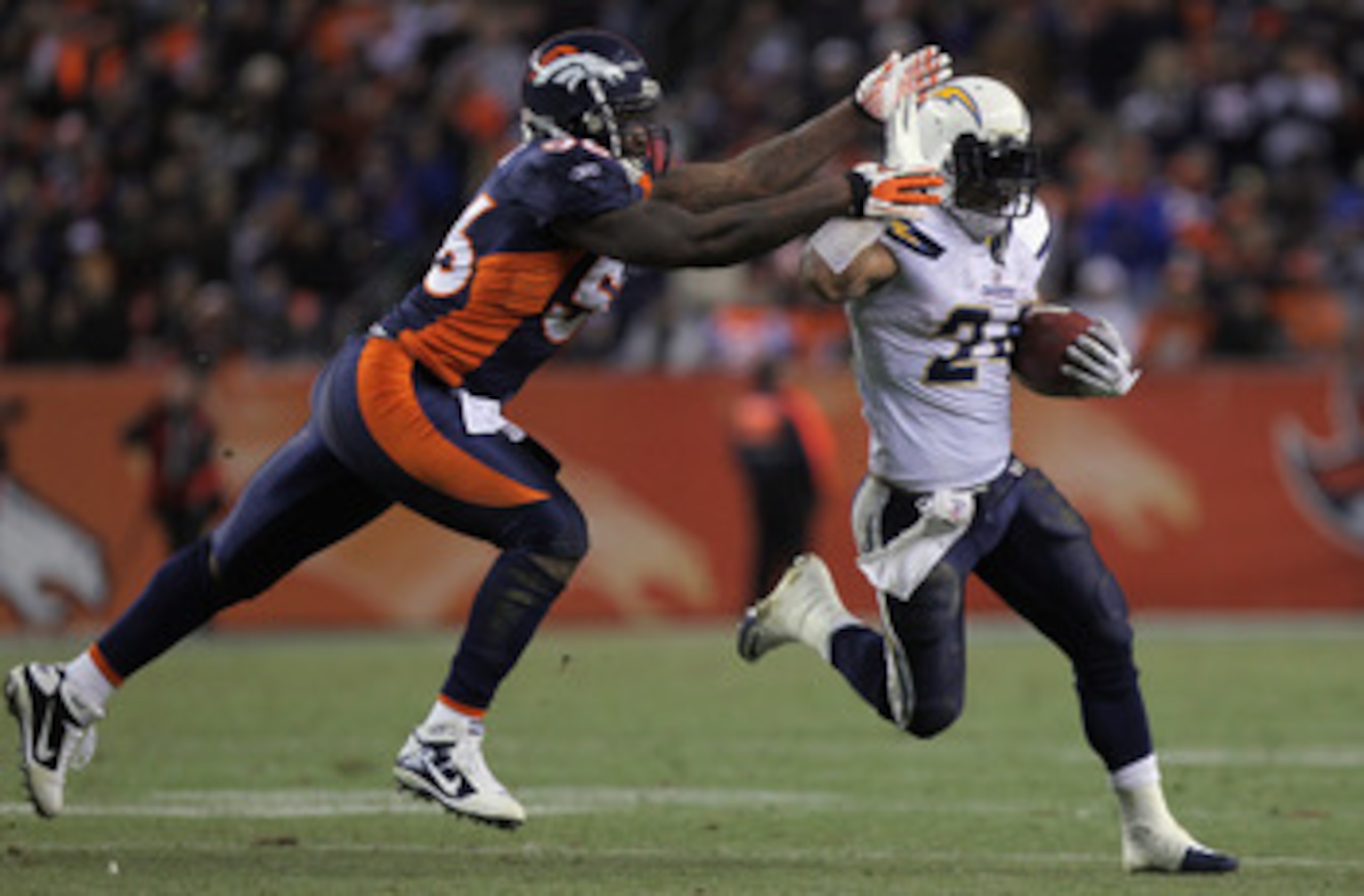 DENVER - JANUARY 02:  Running back Ryan Mathews #24 of the San Diego Chargers eludes linebacker Robert Ayers #56 of the Denver Broncos as he rushes for a 31 yard touchdown on fourth down and one yard to go in the fourth quarter at INVESCO Field at Mile Hi